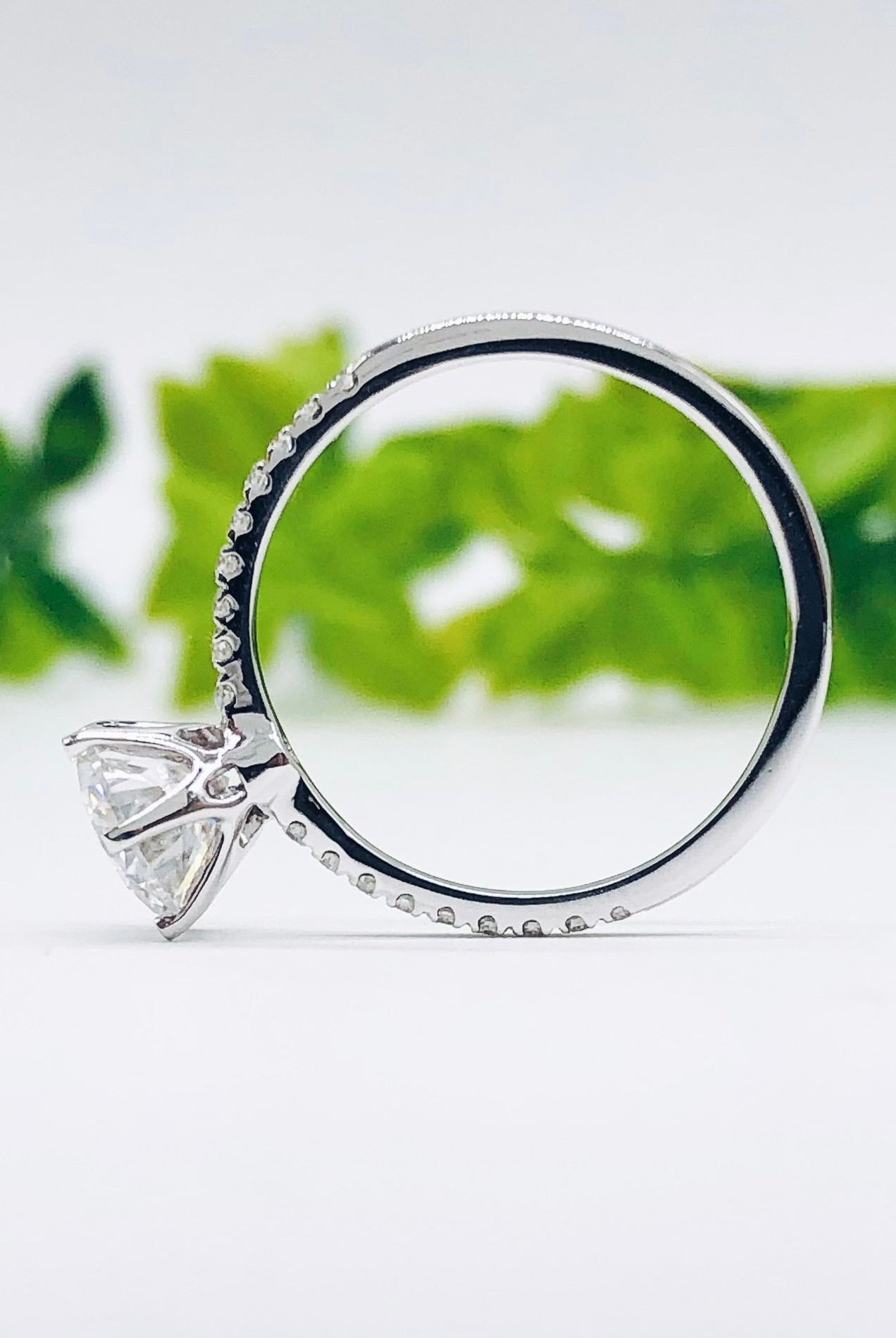 round-cut-solitaire-pave-moissanite-engagement-ring