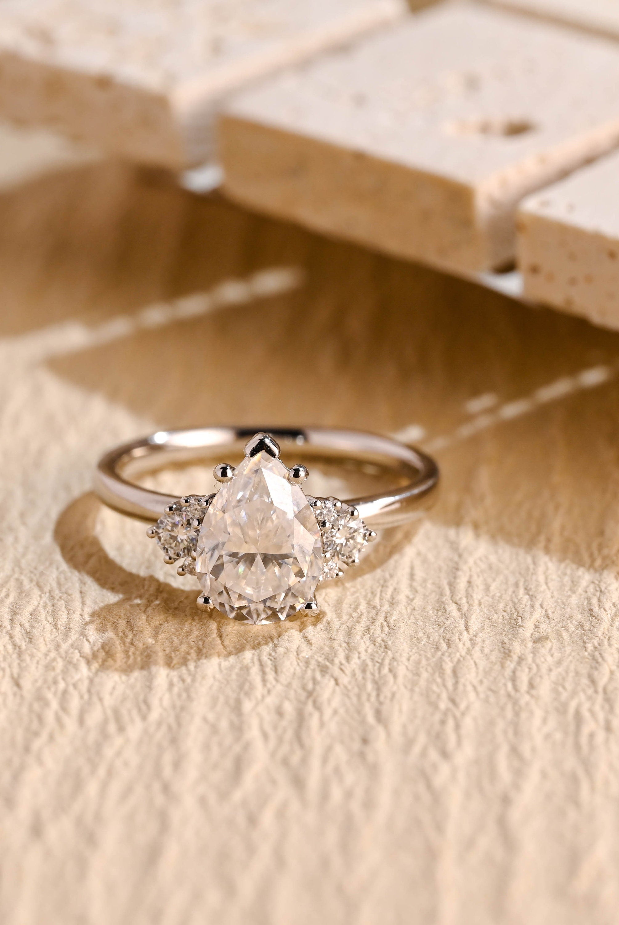 sustainable pear cluster moissanite ring