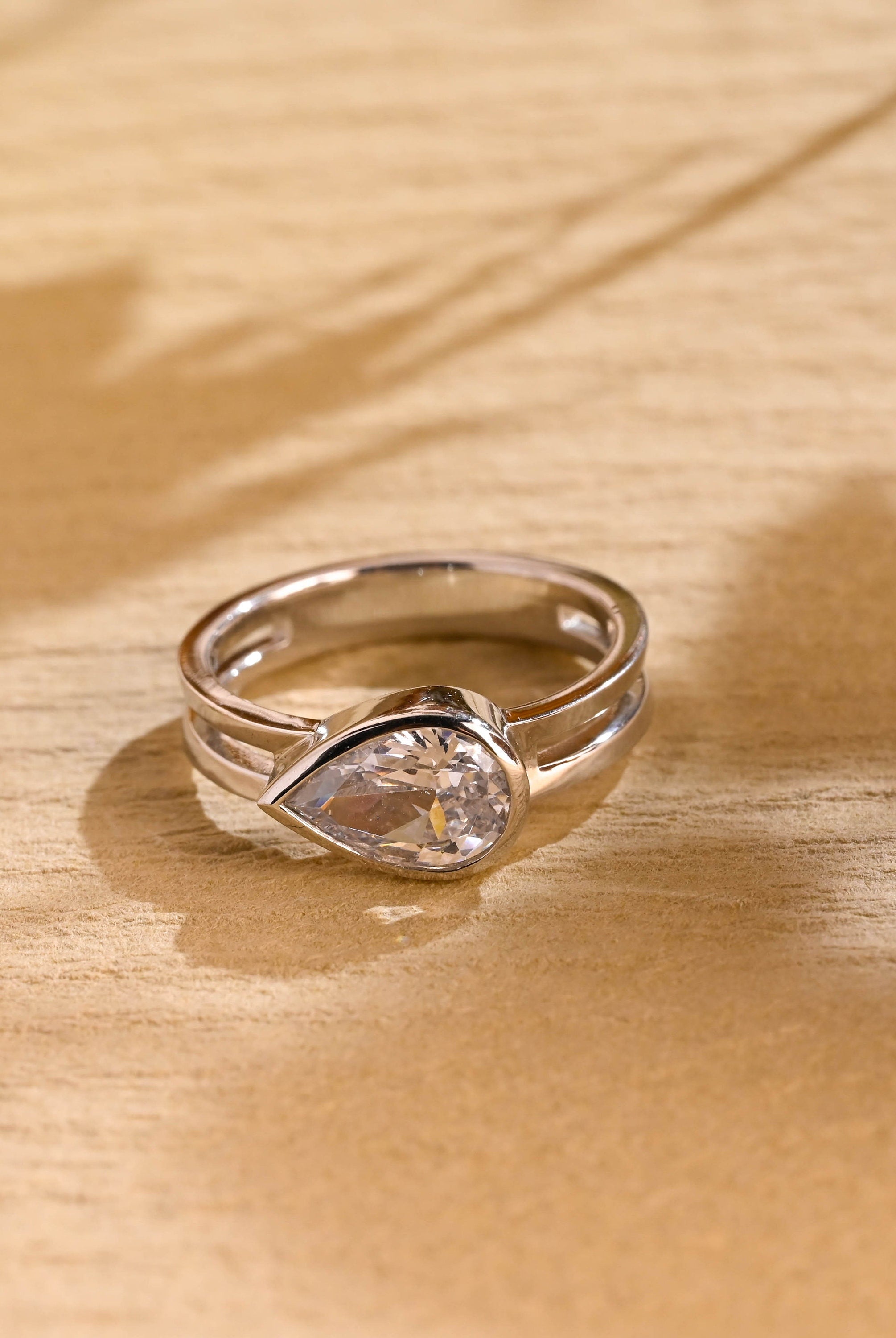1 carat east west pear bezel engagement ring moissanite