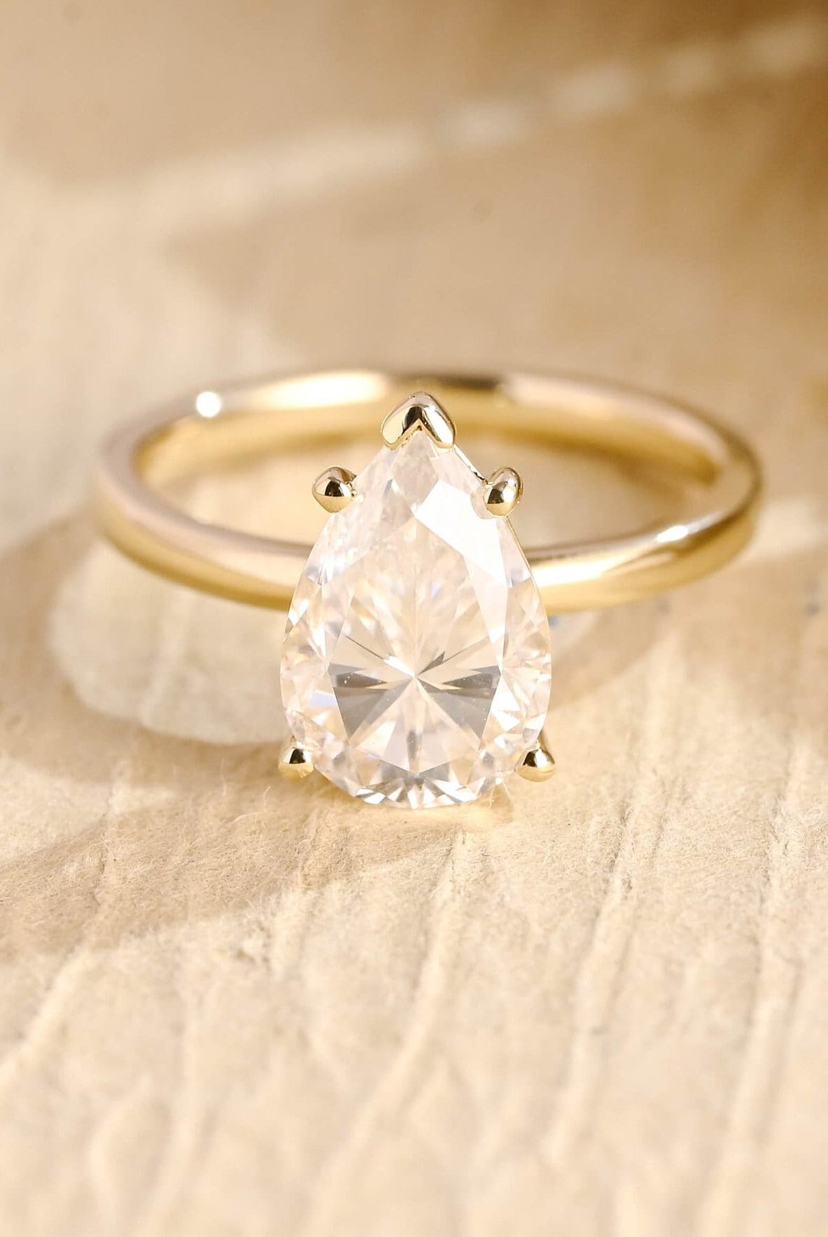 1.5 carat pear cut moissanite engagement ring