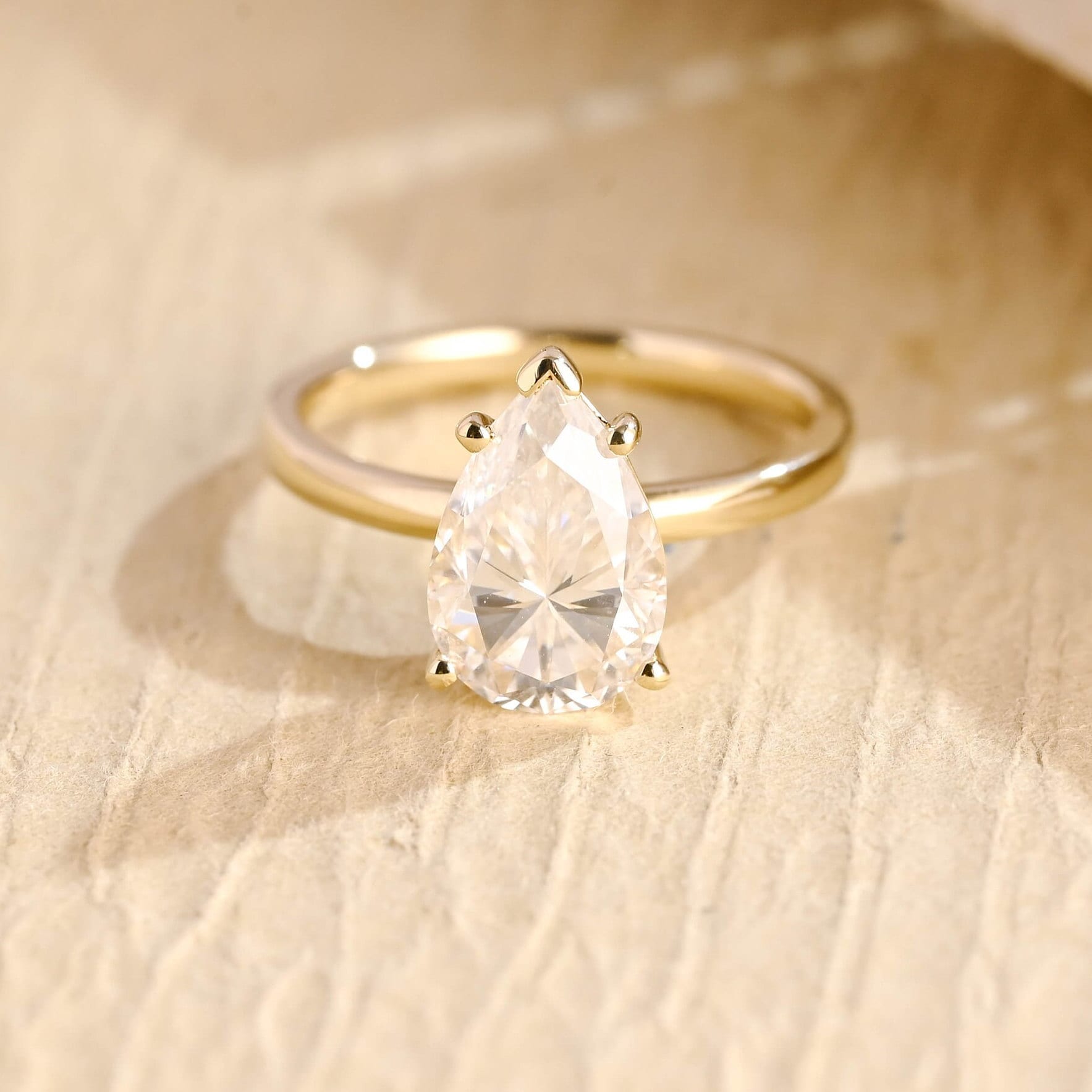 1.5 carat pear cut moissanite engagement ring