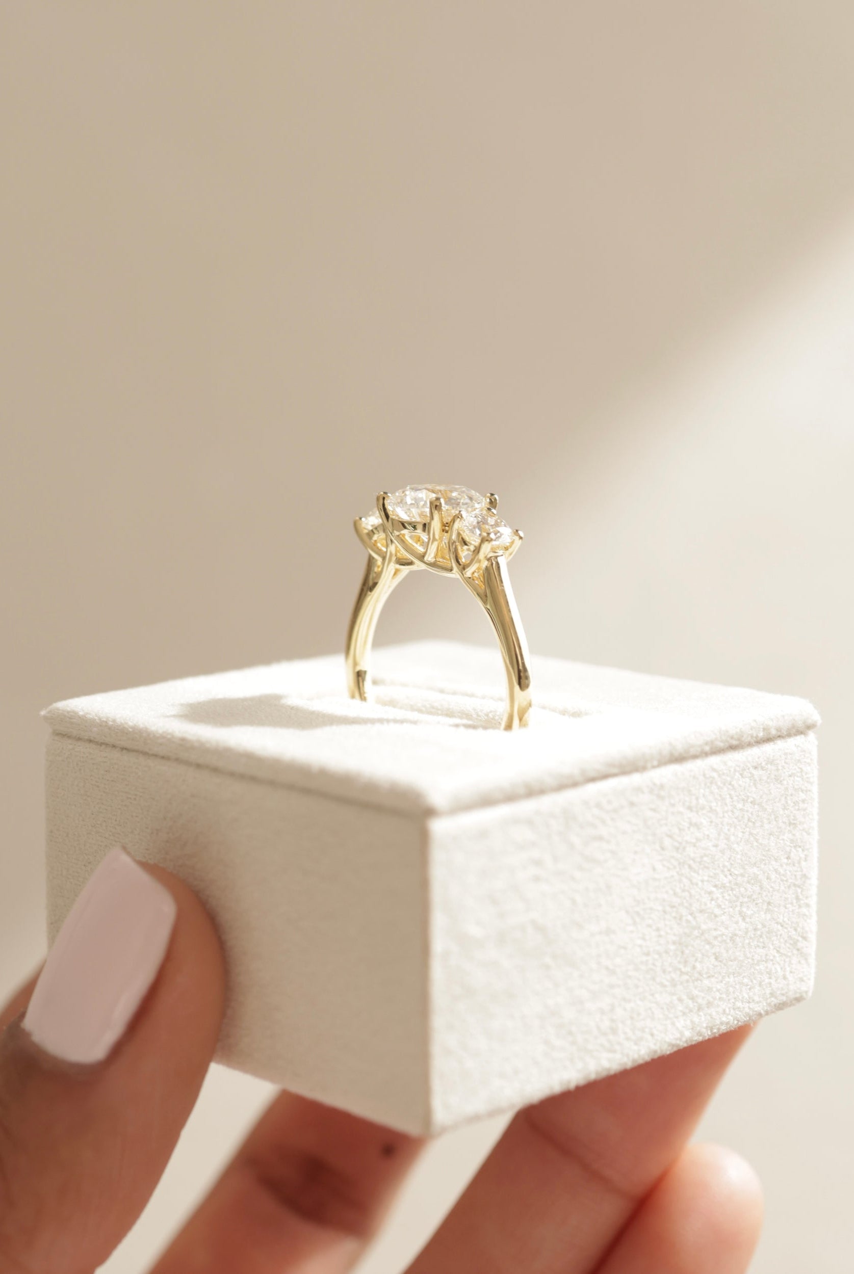 classic three stone design, affordable diamond alternative, handcrafted moissanite engagement ring, timeless round moissanite ring, three stone bridal ring, sparkling moissanite trio ring,