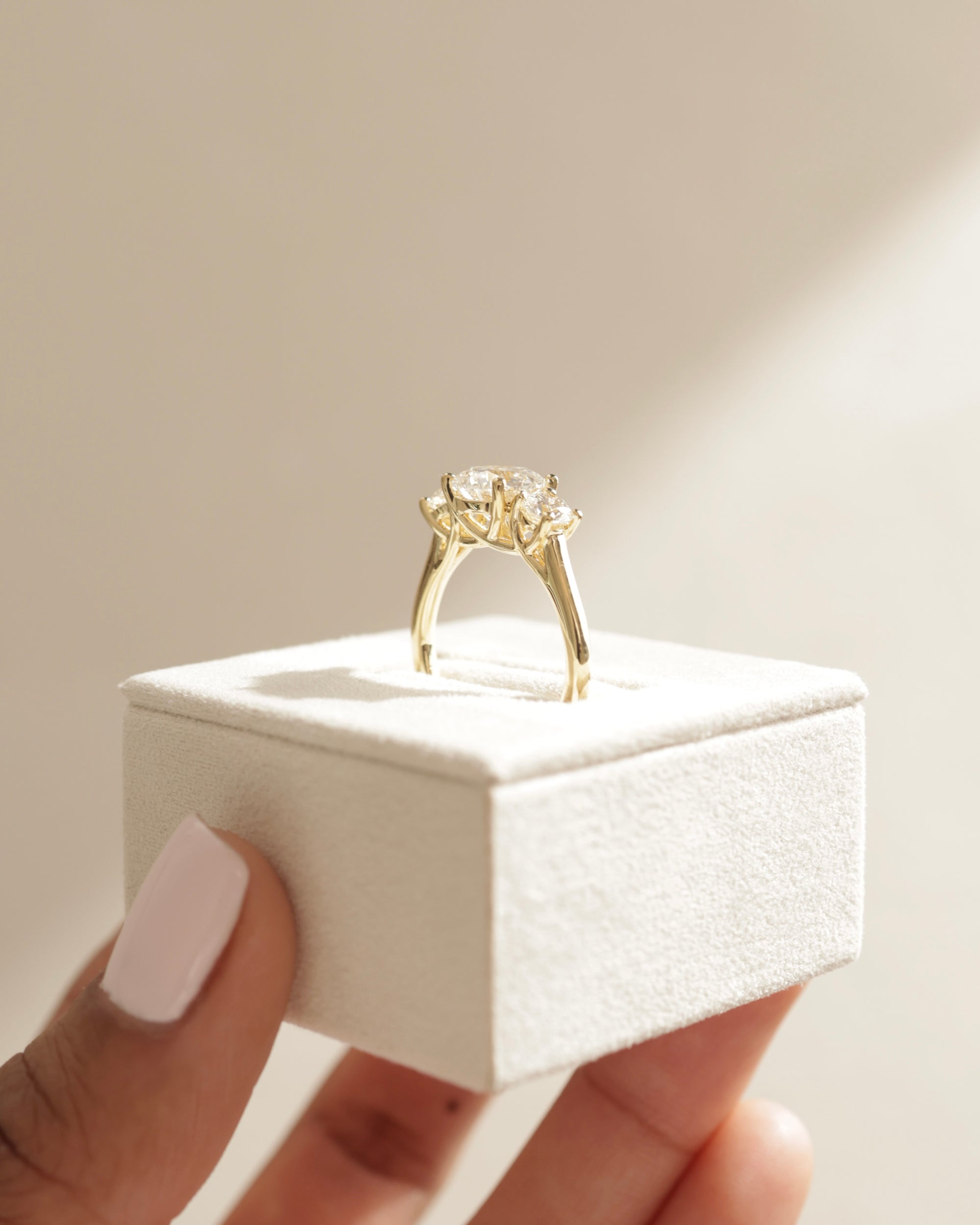 classic three stone design, affordable diamond alternative, handcrafted moissanite engagement ring, timeless round moissanite ring, three stone bridal ring, sparkling moissanite trio ring,