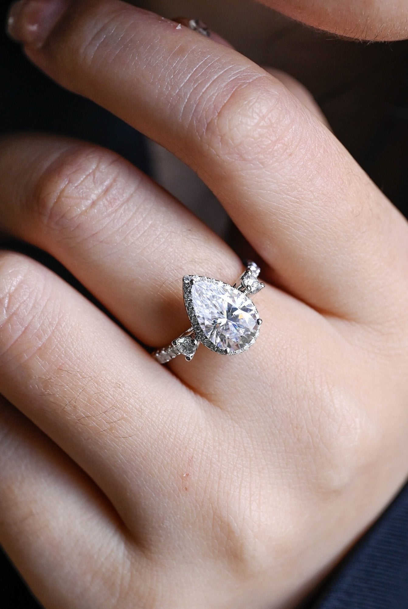 sparkling pear cut three stone moissanite ring