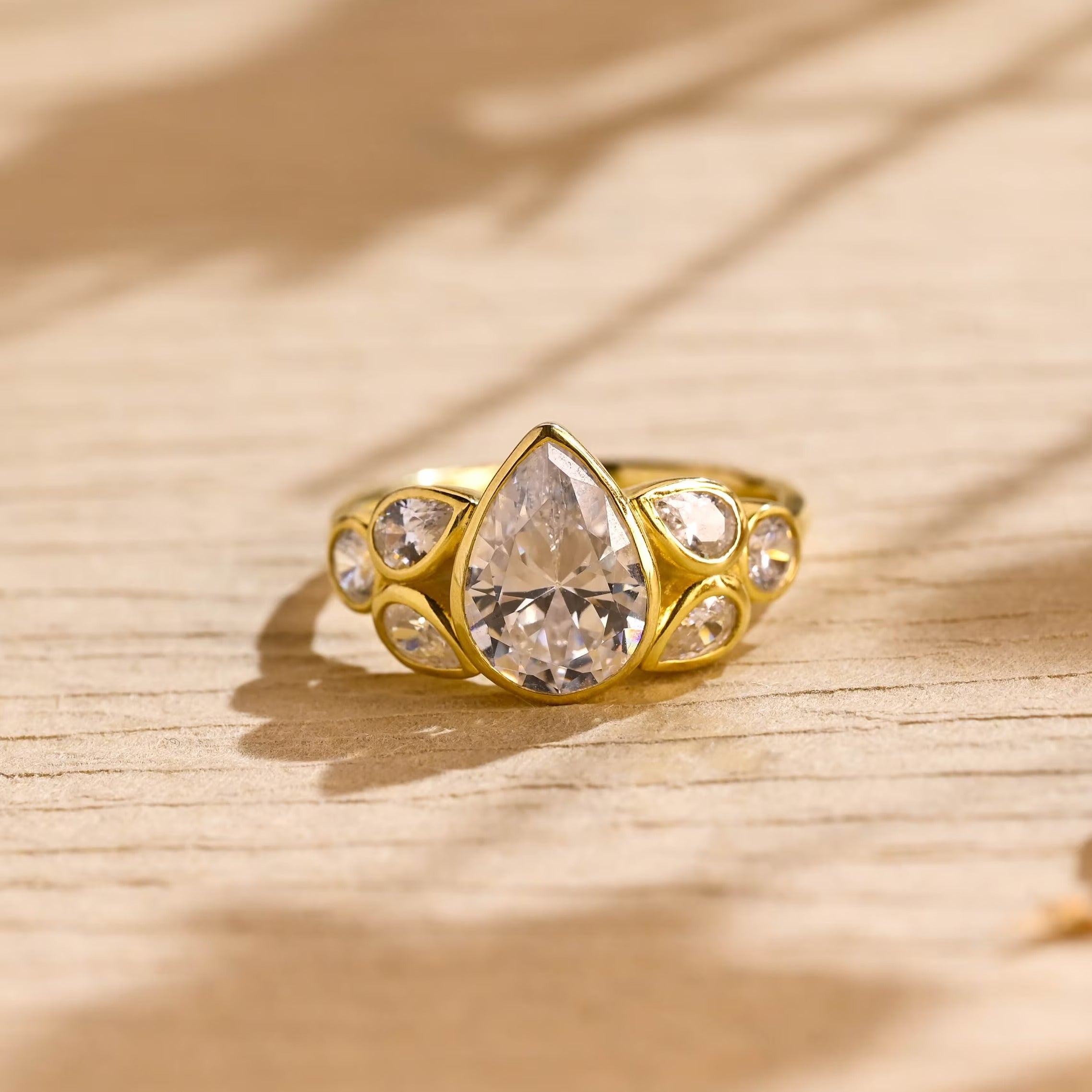pear cut seven stone bezel moissanite engagement ring