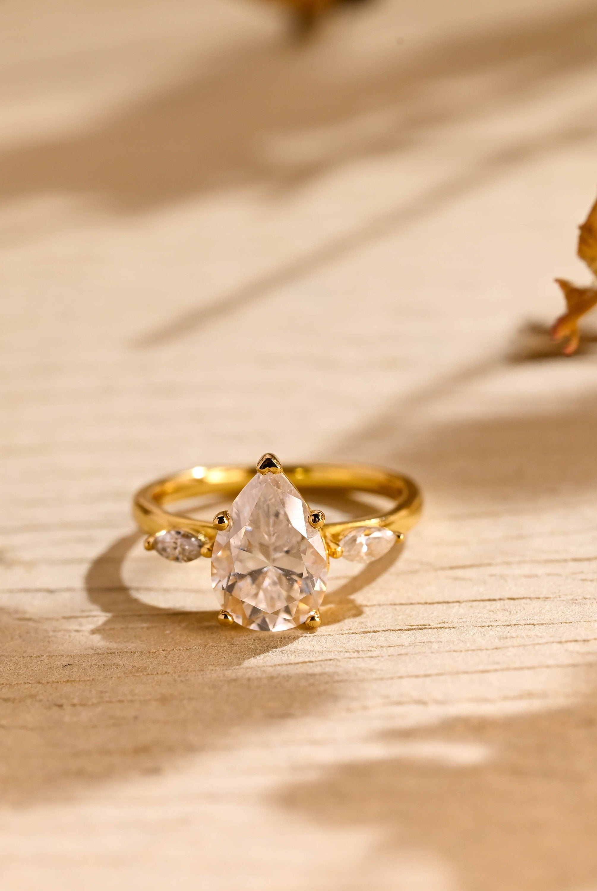 pear cut three stone moissanite engagement ring