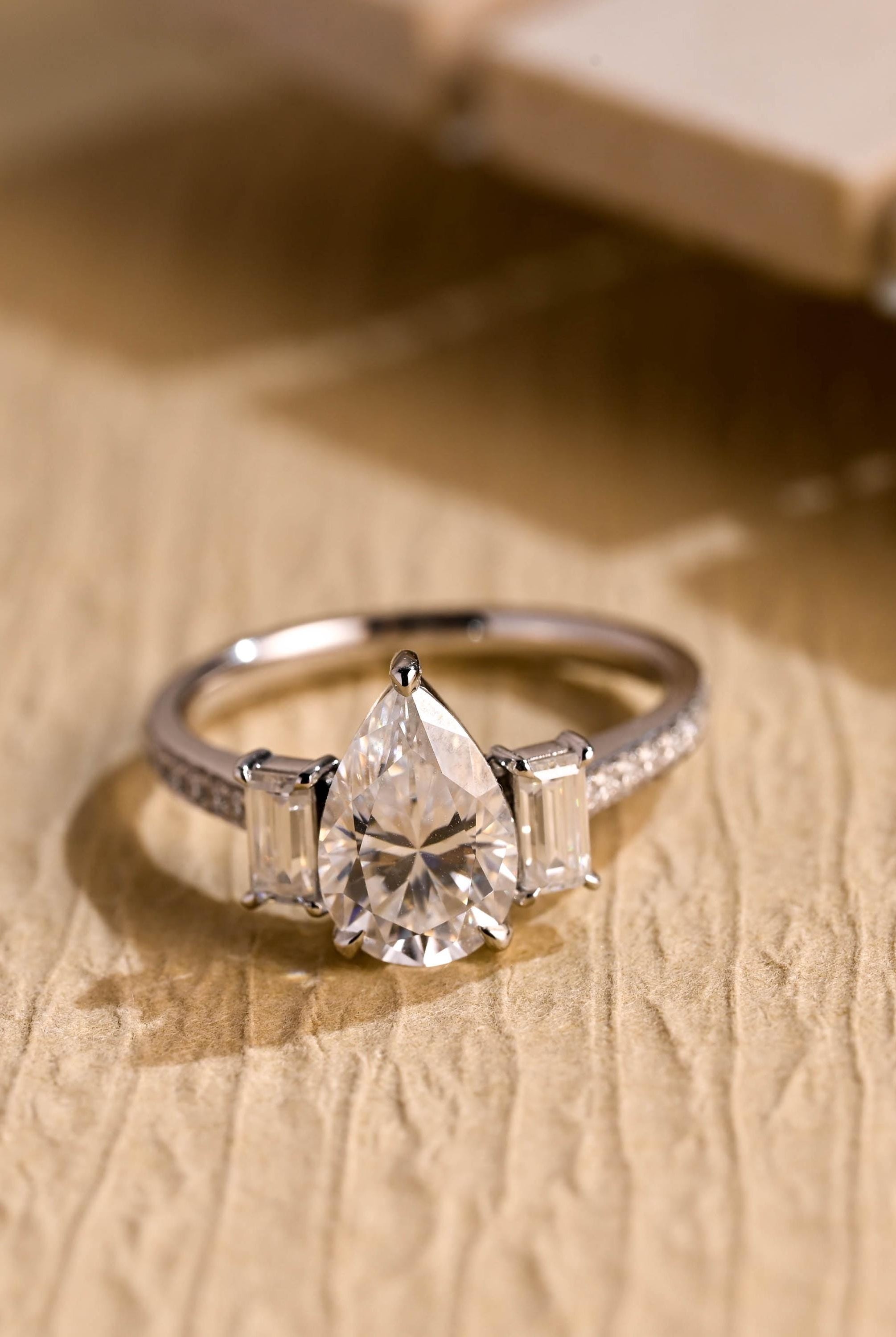 pear cut three stone pavé moissanite engagement ring