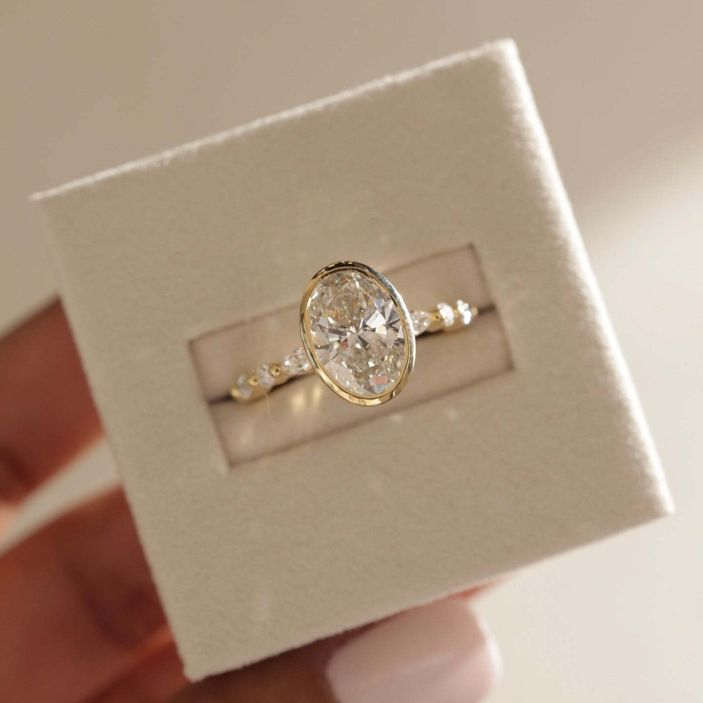 oval diamond ring for her, oval cut diamond gold band, custom oval diamond ring, modern oval engagement ring, oval cut diamond with side stones, oval cut diamond ring setting, oval diamond prong setting, luxury oval diamond ring