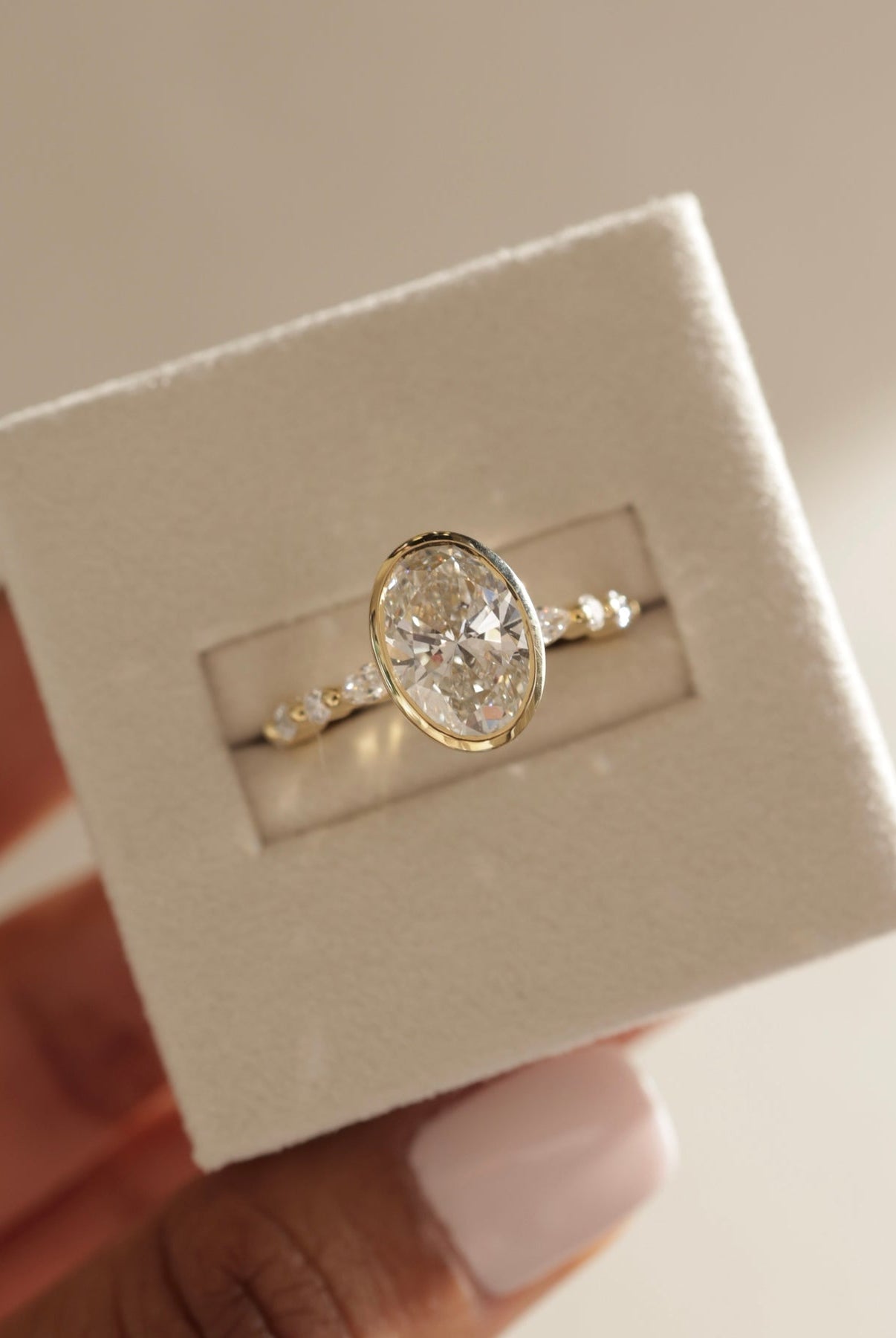 oval diamond ring for her, oval cut diamond gold band, custom oval diamond ring, modern oval engagement ring, oval cut diamond with side stones, oval cut diamond ring setting, oval diamond prong setting, luxury oval diamond ring