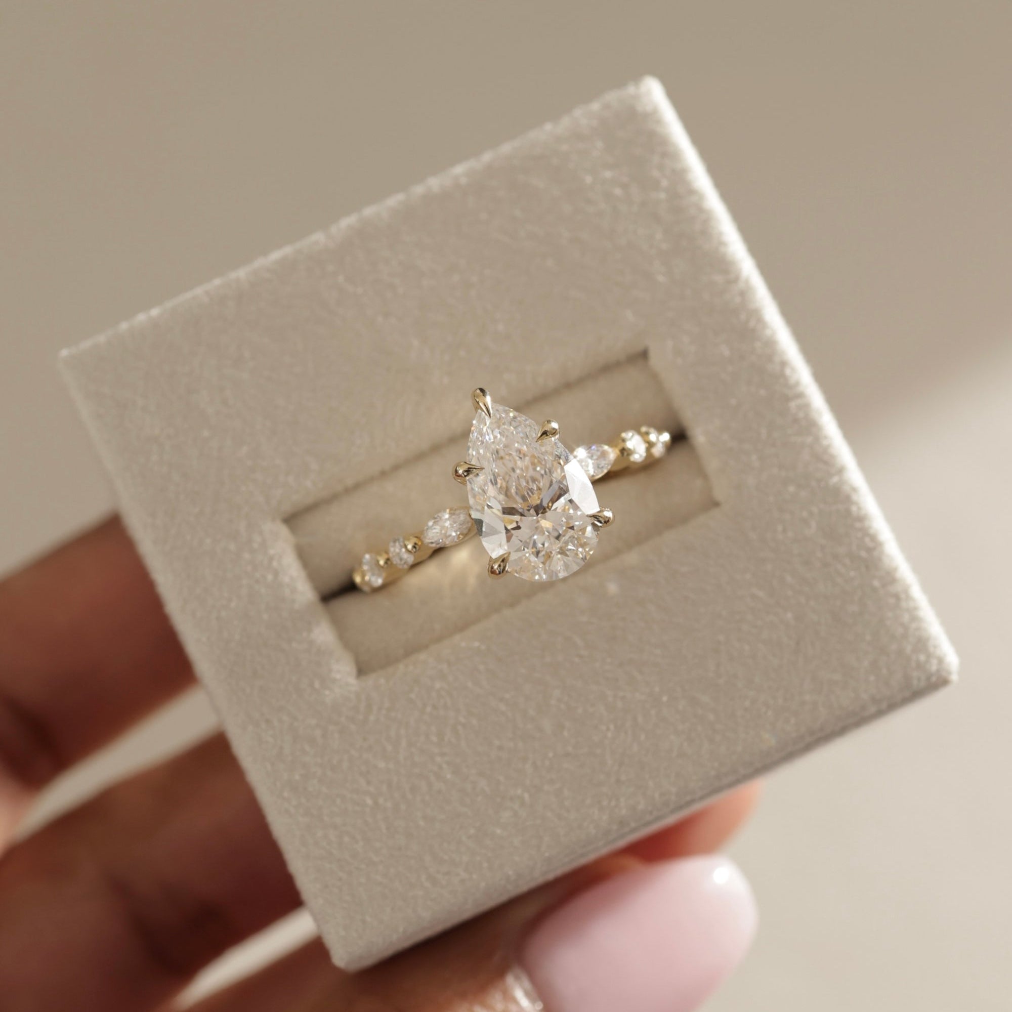 elegant pear diamond ring, pear shaped ring for her, pear cut diamond with side stones, pear diamond three stone ring, pear shaped diamond gold band