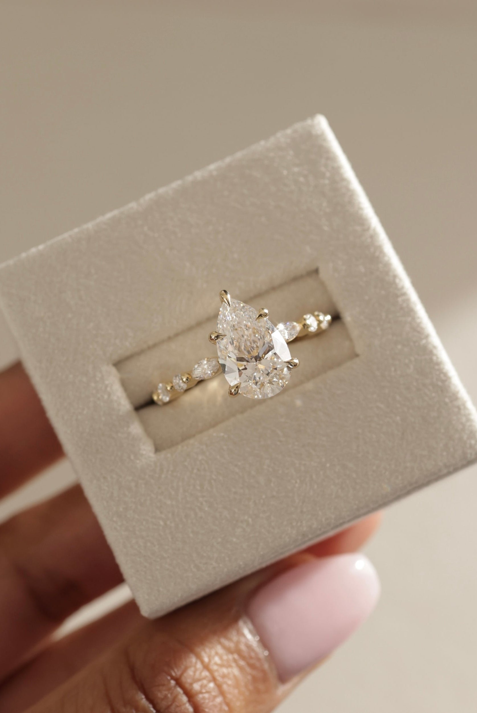 elegant pear diamond ring, pear shaped ring for her, pear cut diamond with side stones, pear diamond three stone ring, pear shaped diamond gold band