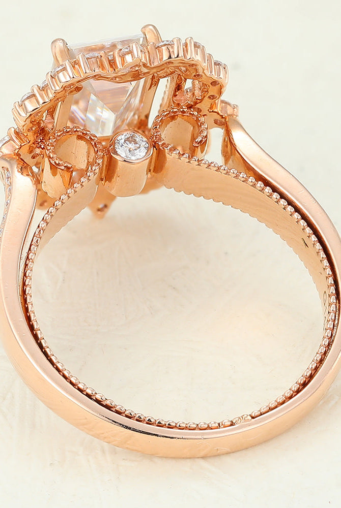 emerald-shaped-moissanite-cluster-halo-engagement-ring