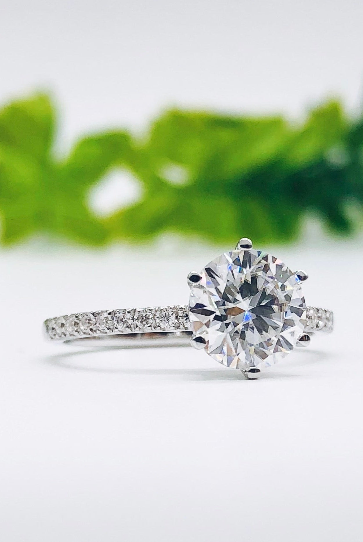 round-cut-solitaire-pave-moissanite-engagement-ring