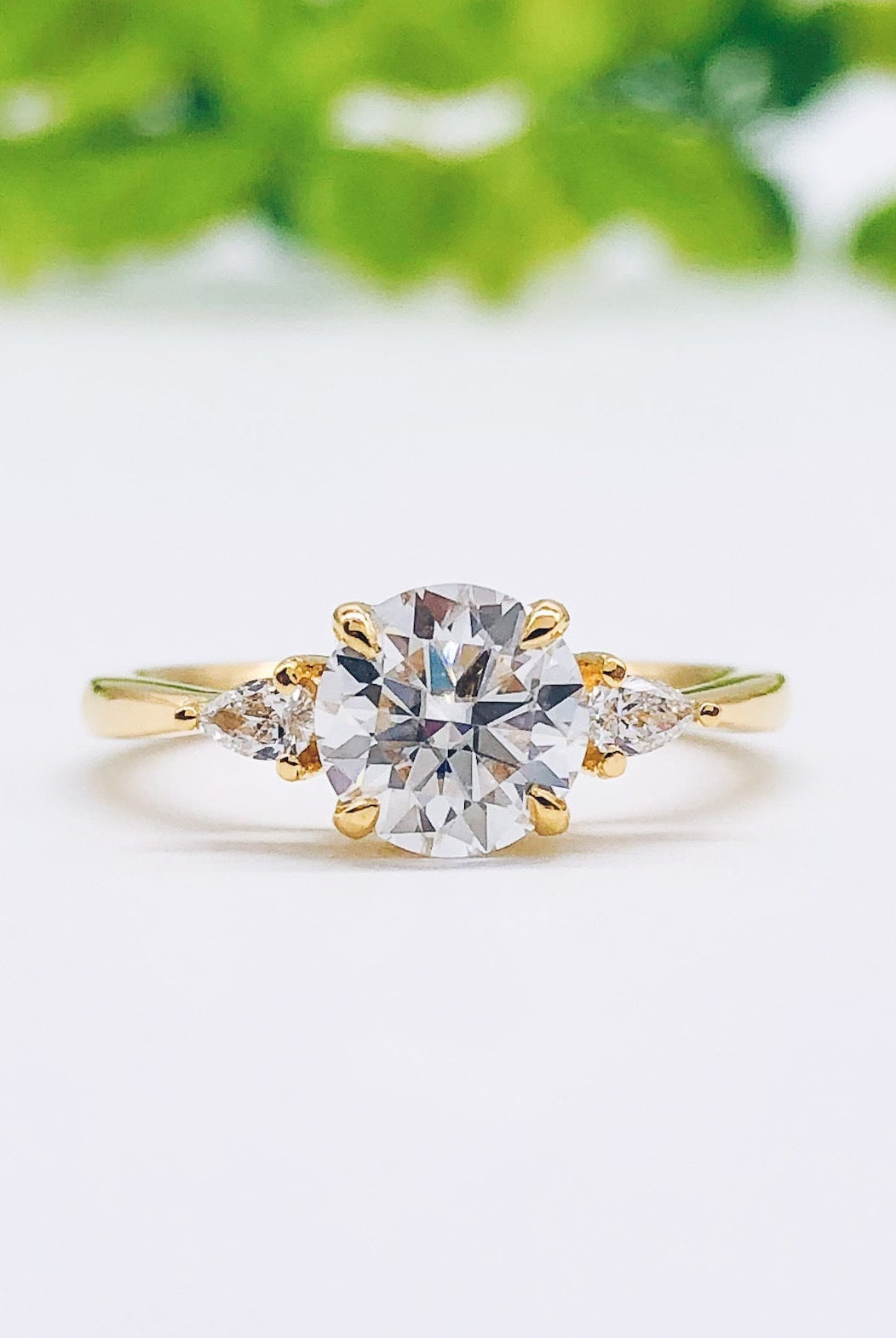 round-cut-three-stone-moissanite-engagement-ring