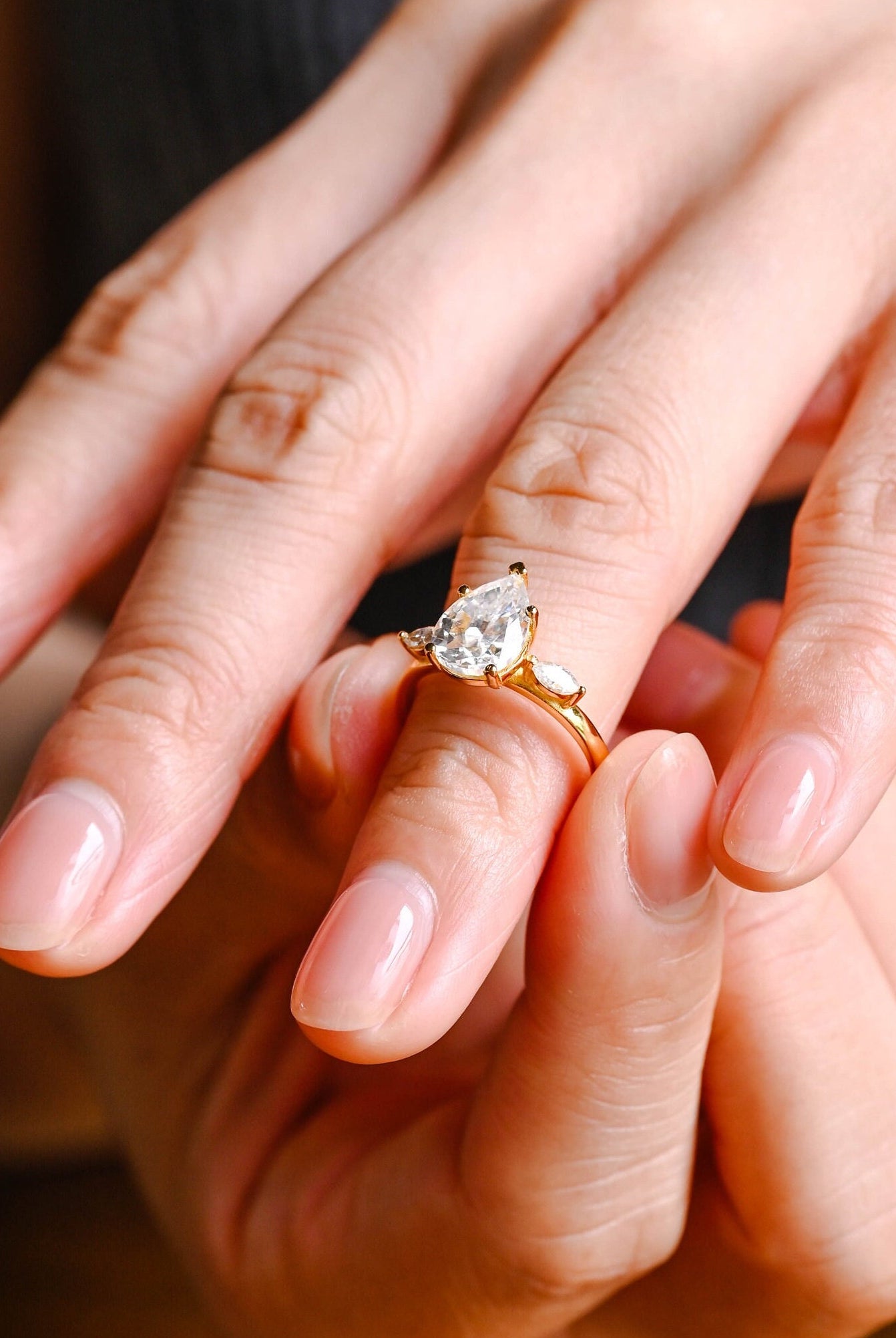 high sparkle pear three stone moissanite engagement ring