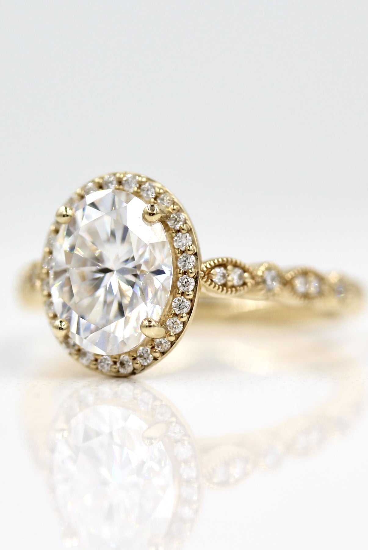 Vintage-inspired halo moissanite engagement rings with diamond accents