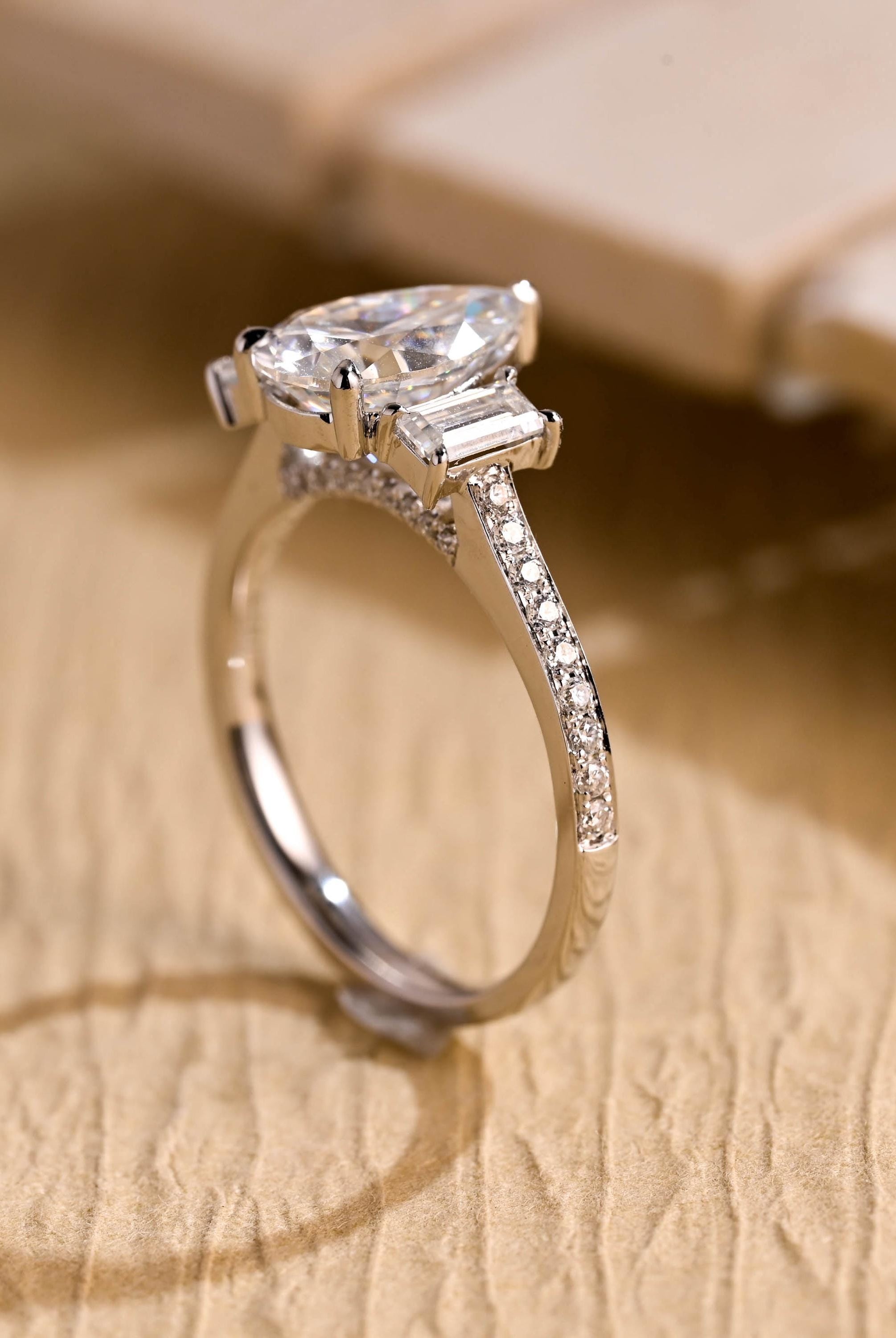 gold pavé three stone pear moissanite engagement ring
