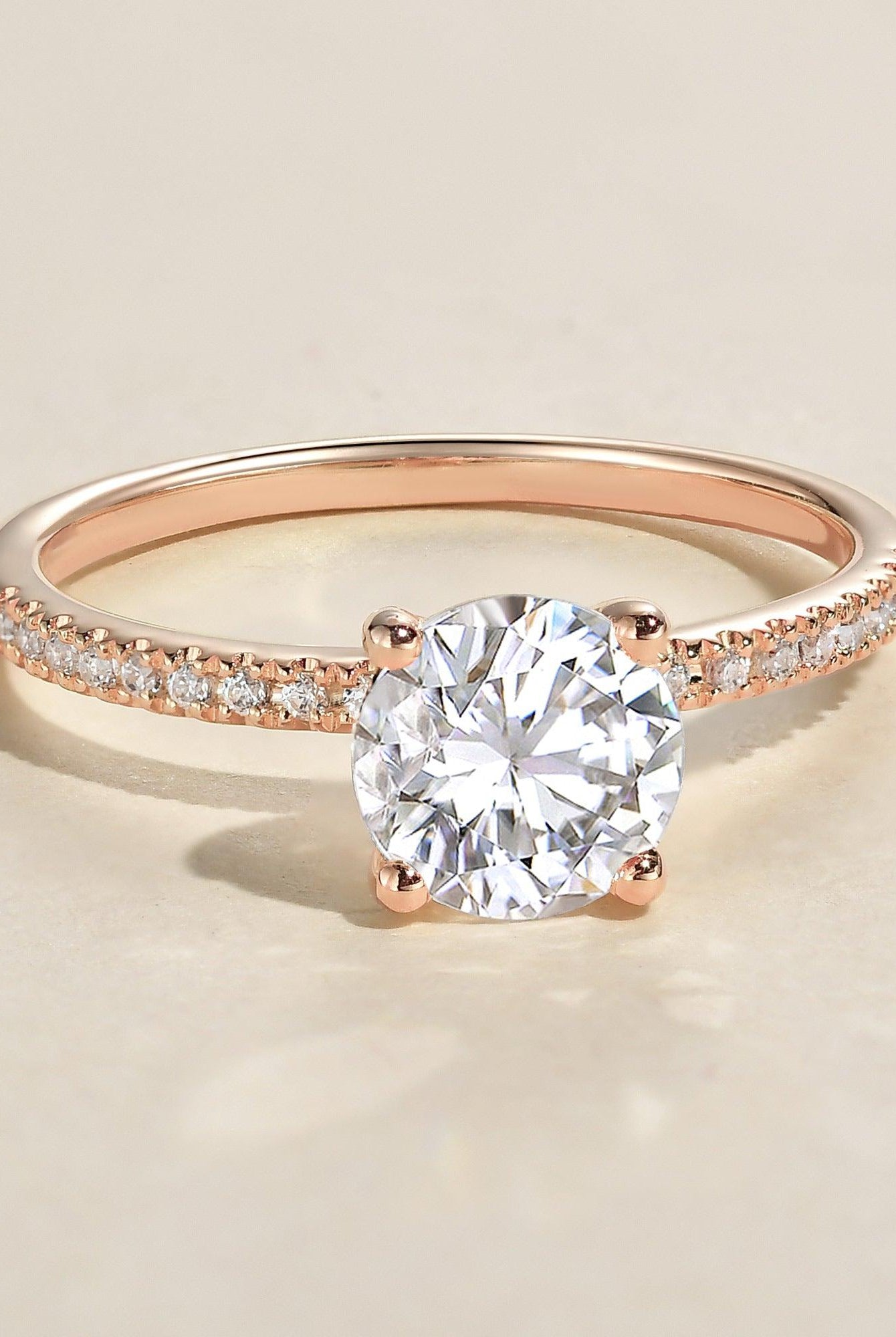 round-cut-solitaire-pave-moissanite-engagement-ring
