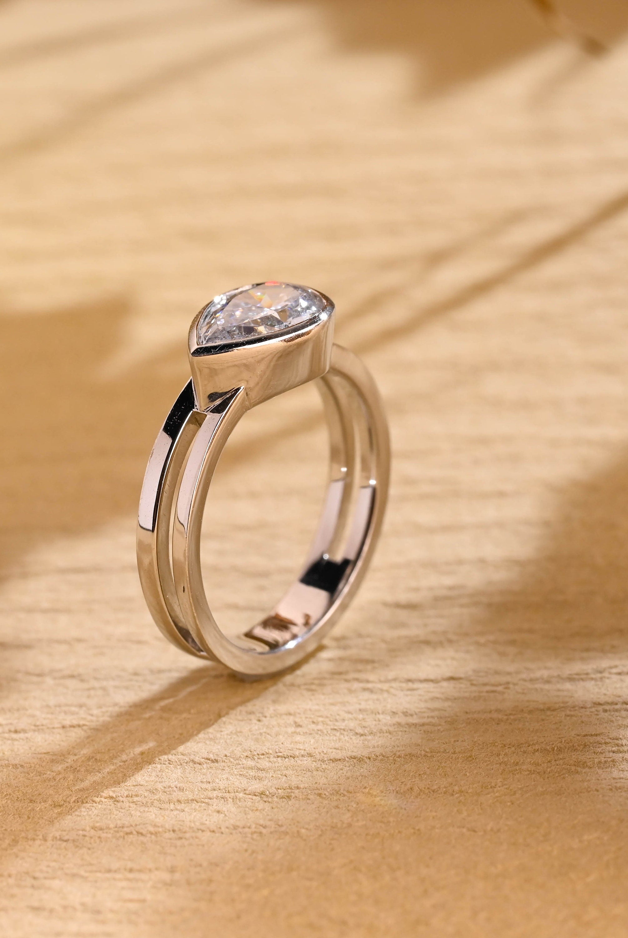 diamond alternative pear bezel engagement ring