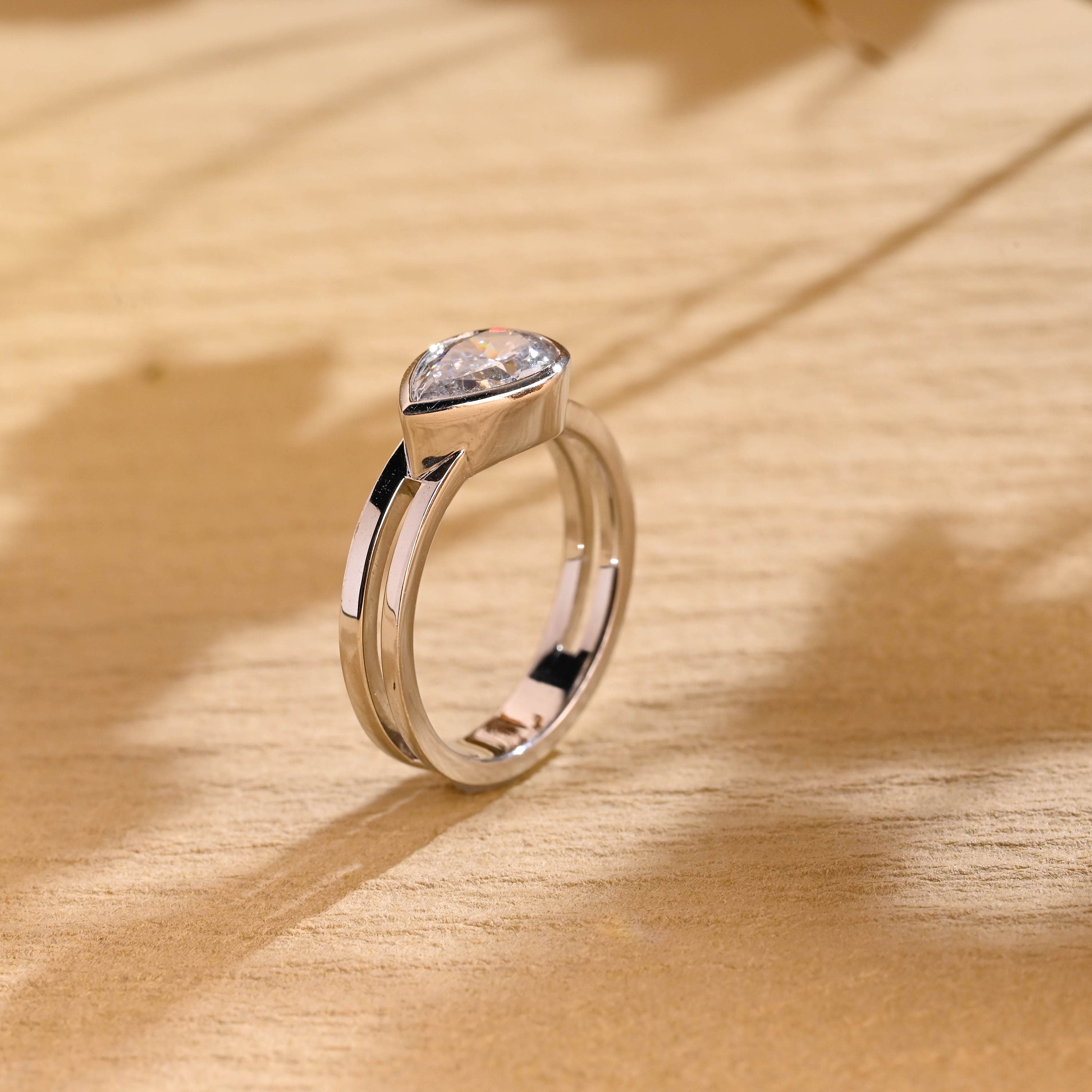 diamond alternative pear bezel engagement ring