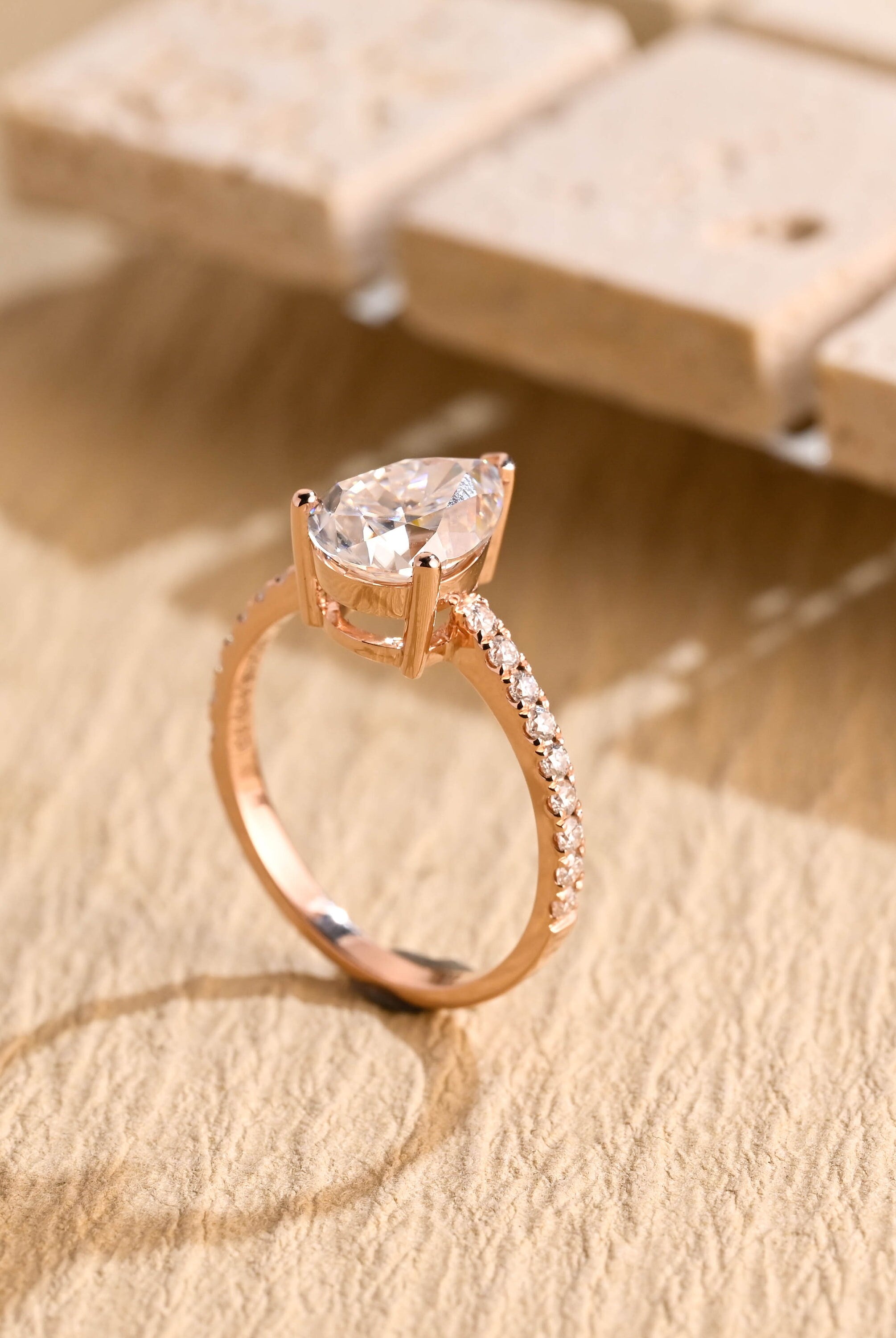 halo alternative pear pavé moissanite ring
