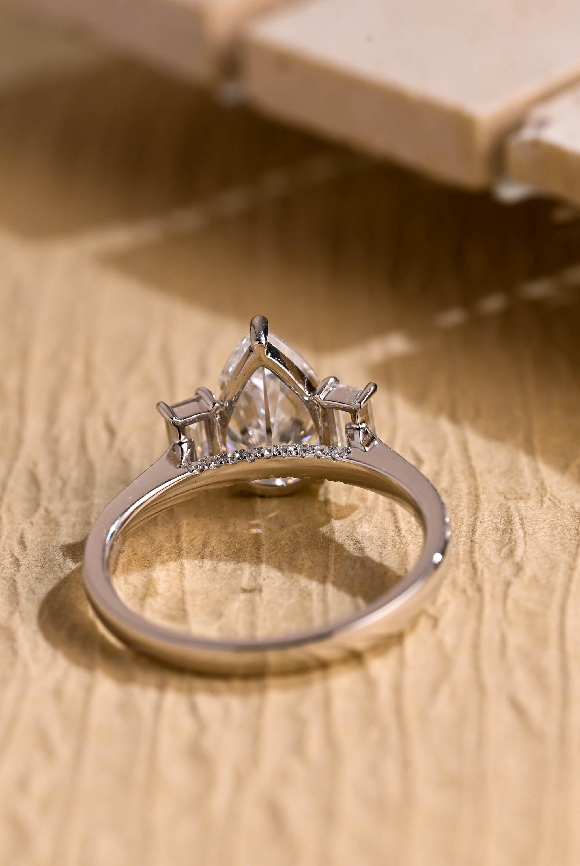 1ct pear moissanite three stone engagement ring pavé