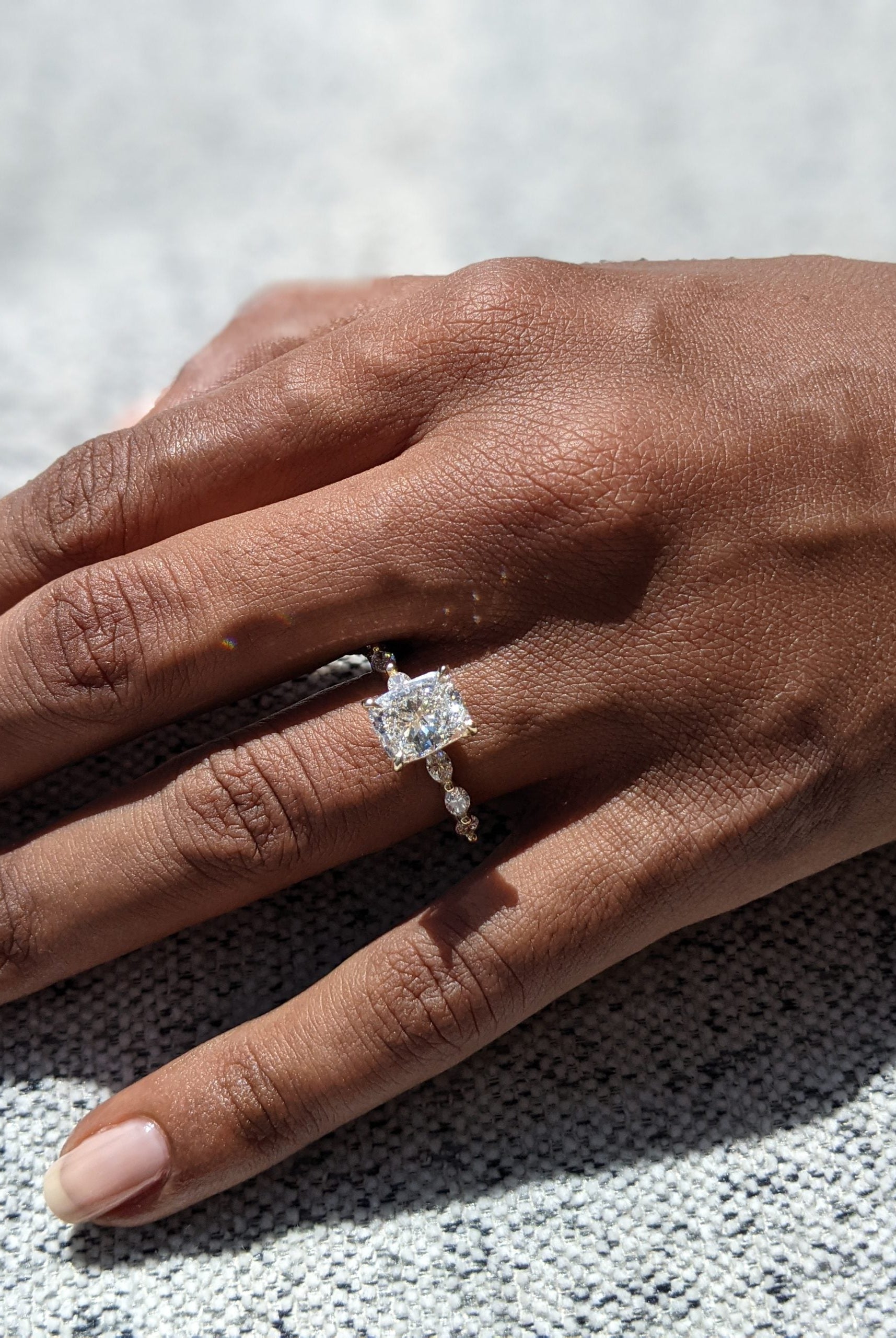 Elongated Cushion Engagement Ring Featuring a Pave Diamond Setting