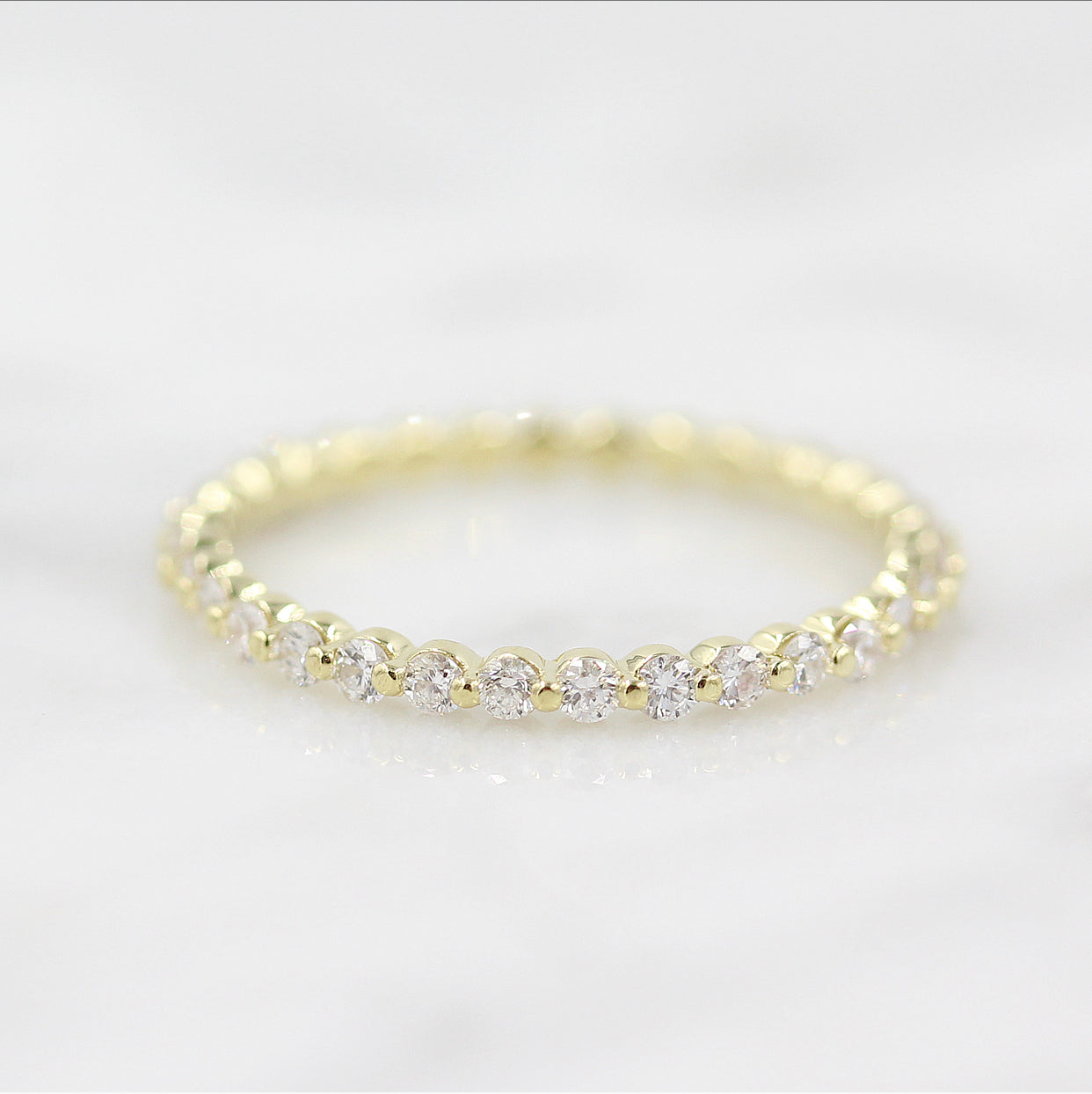 round-cut-half-eternity-moissanite-wedding-band