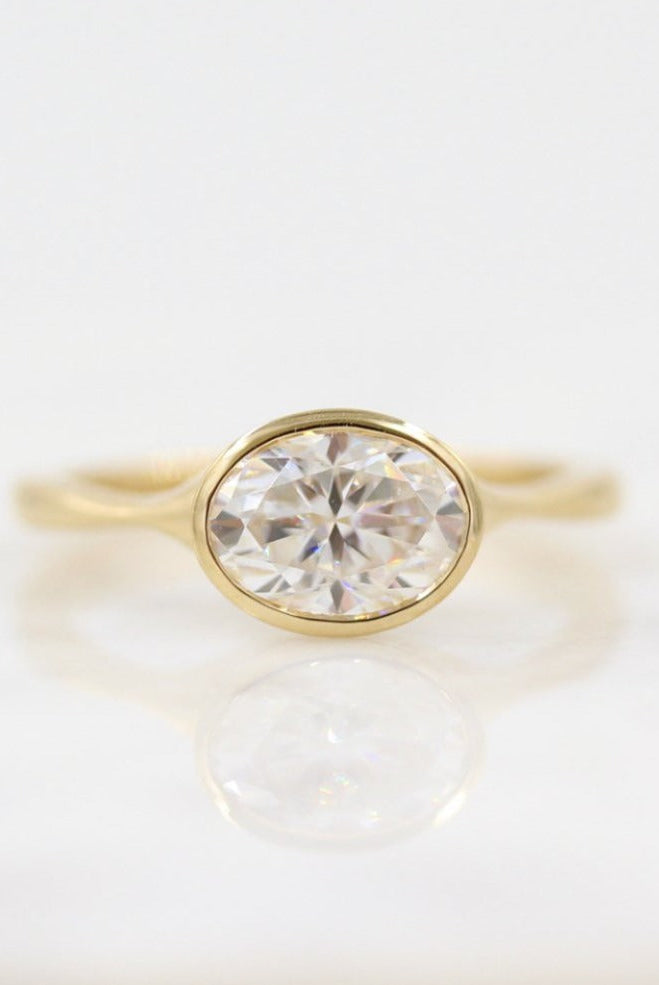 Vintage-inspired oval moissanite engagement rings with diamond accents