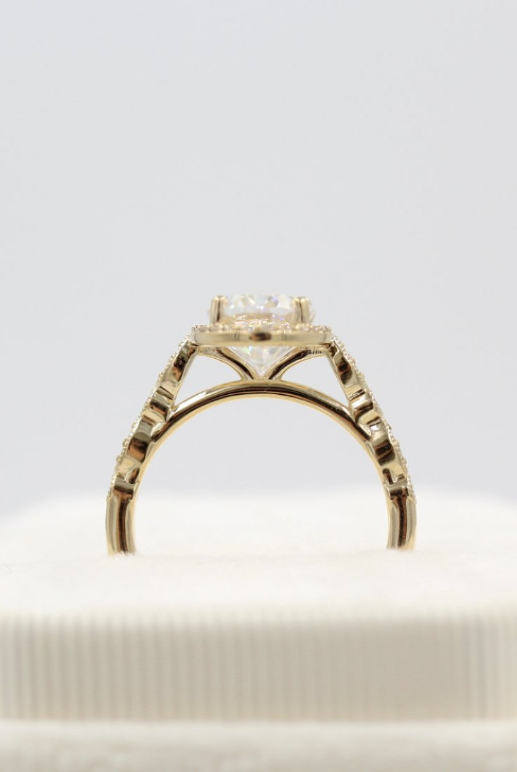Vintage-inspired solitaire moissanite engagement rings with diamond accents