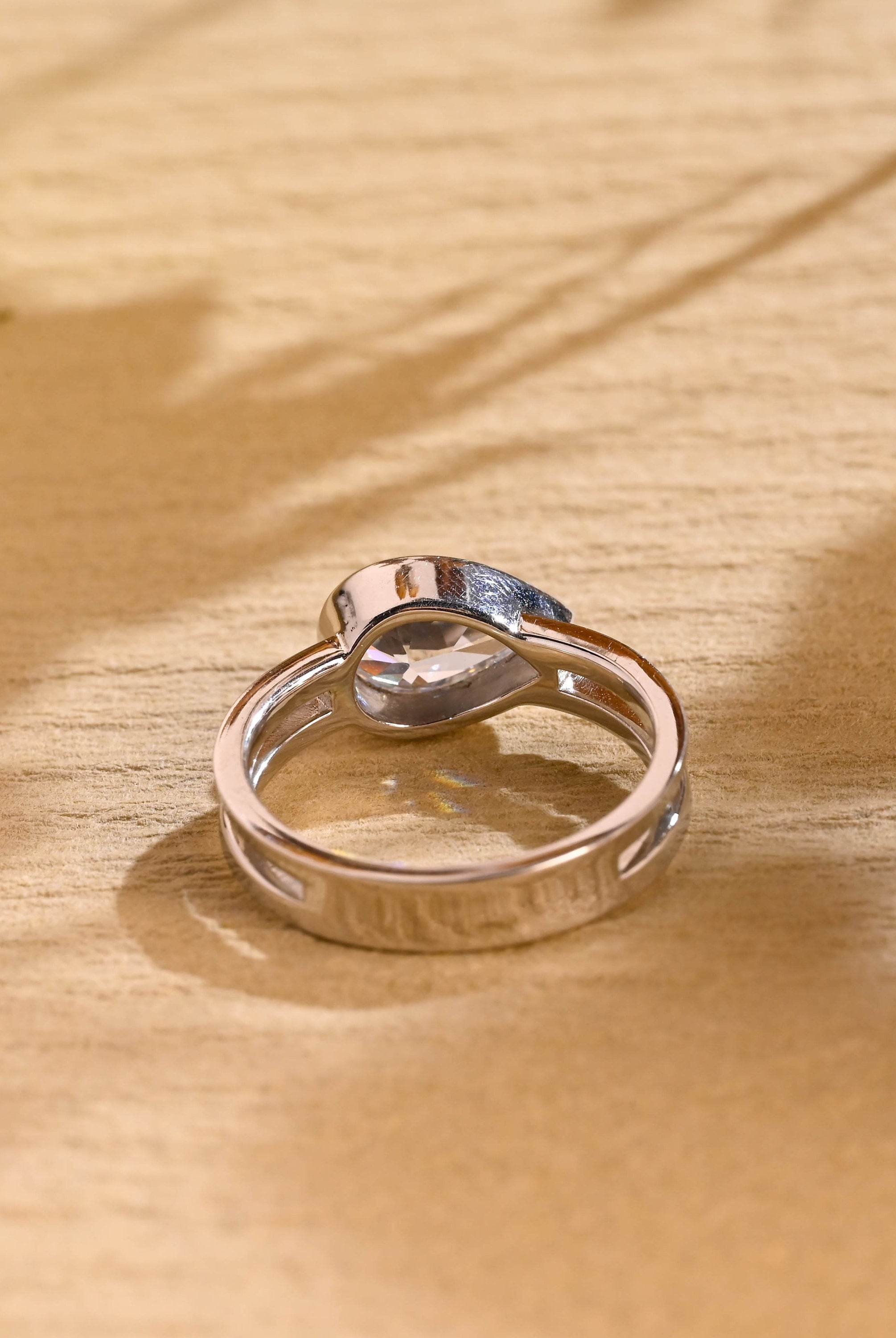 horizontal pear bezel engagement ring moissanite