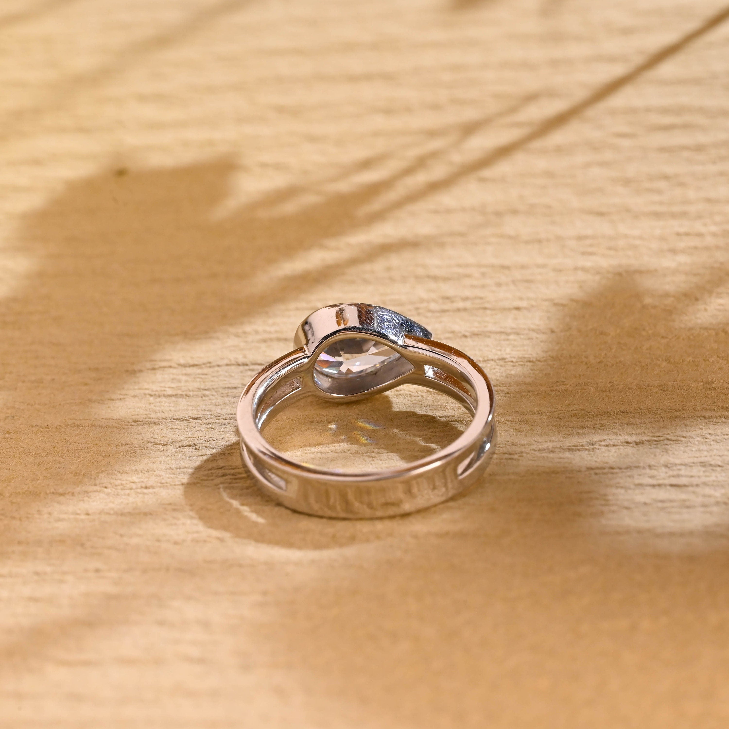 horizontal pear bezel engagement ring moissanite