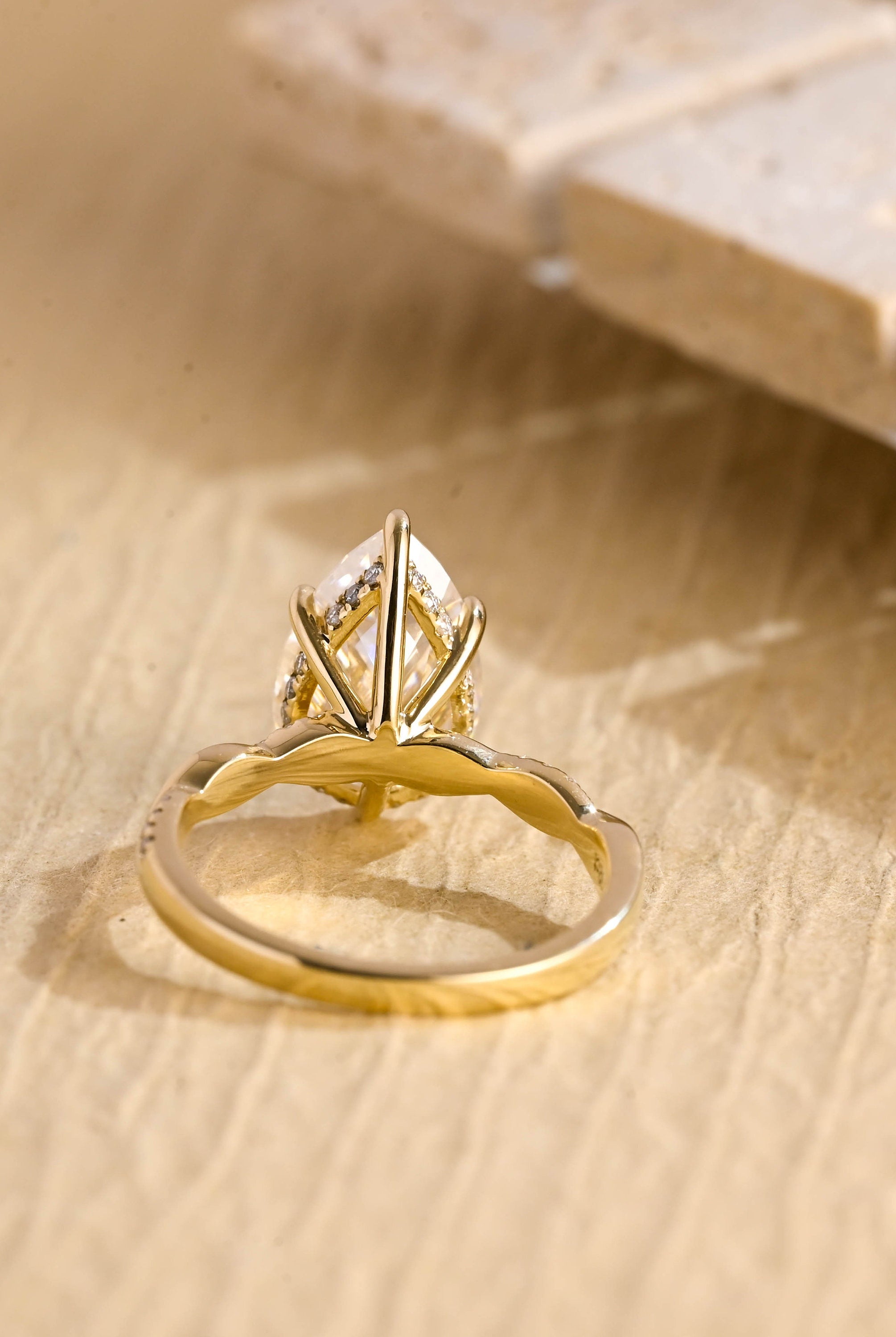 twisted band pear engagement ring moissanite