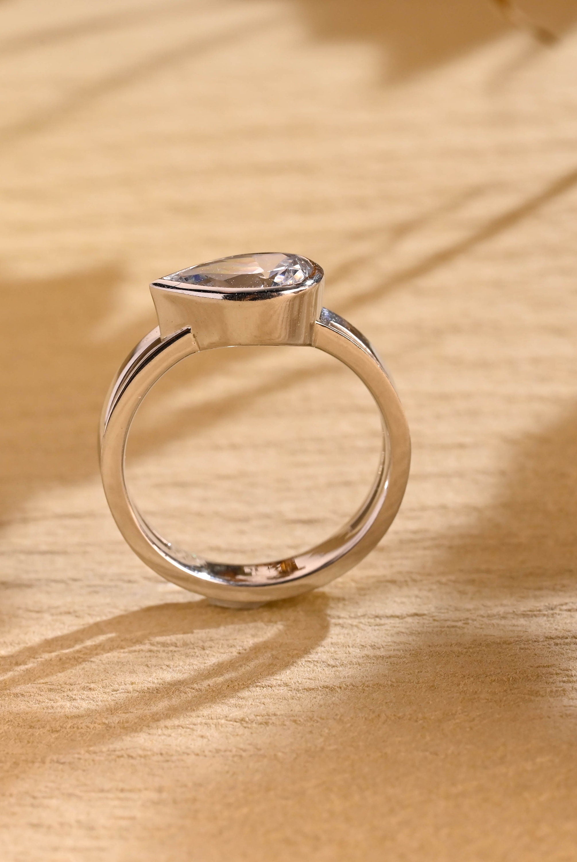 sustainable pear bezel engagement ring moissanite
