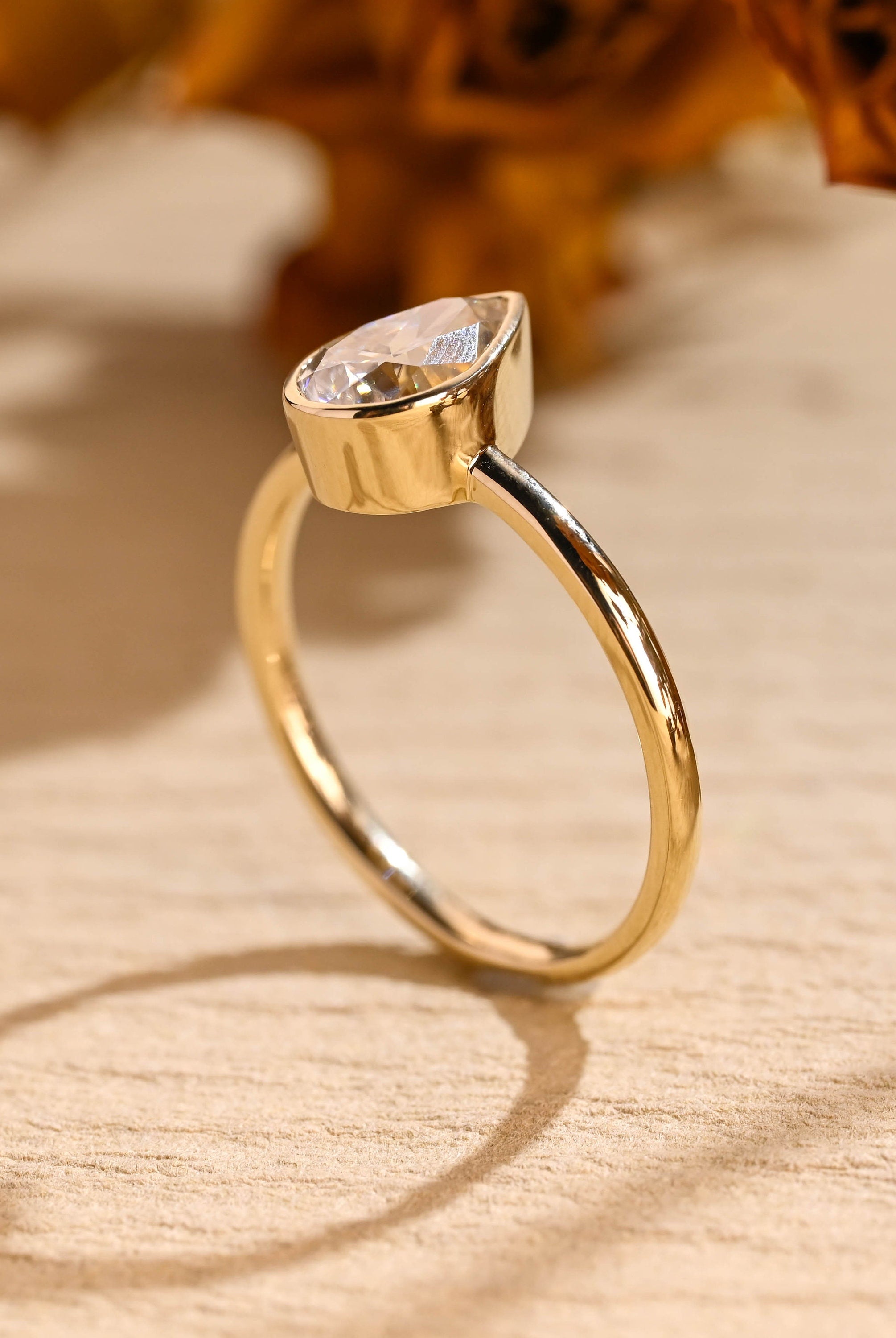 modern pear bezel solitaire engagement ring moissanite