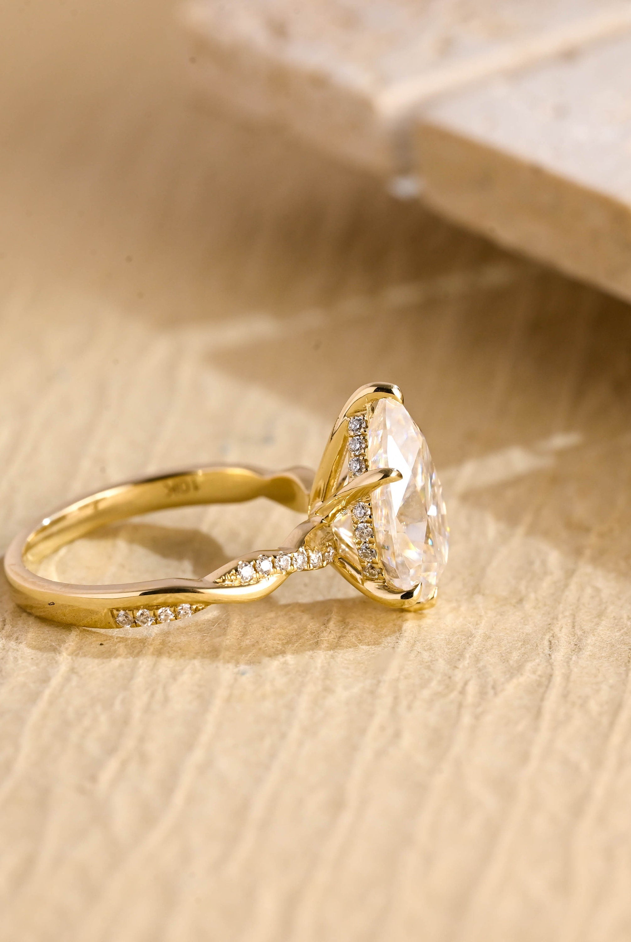 twisted band pear engagement ring moissanite