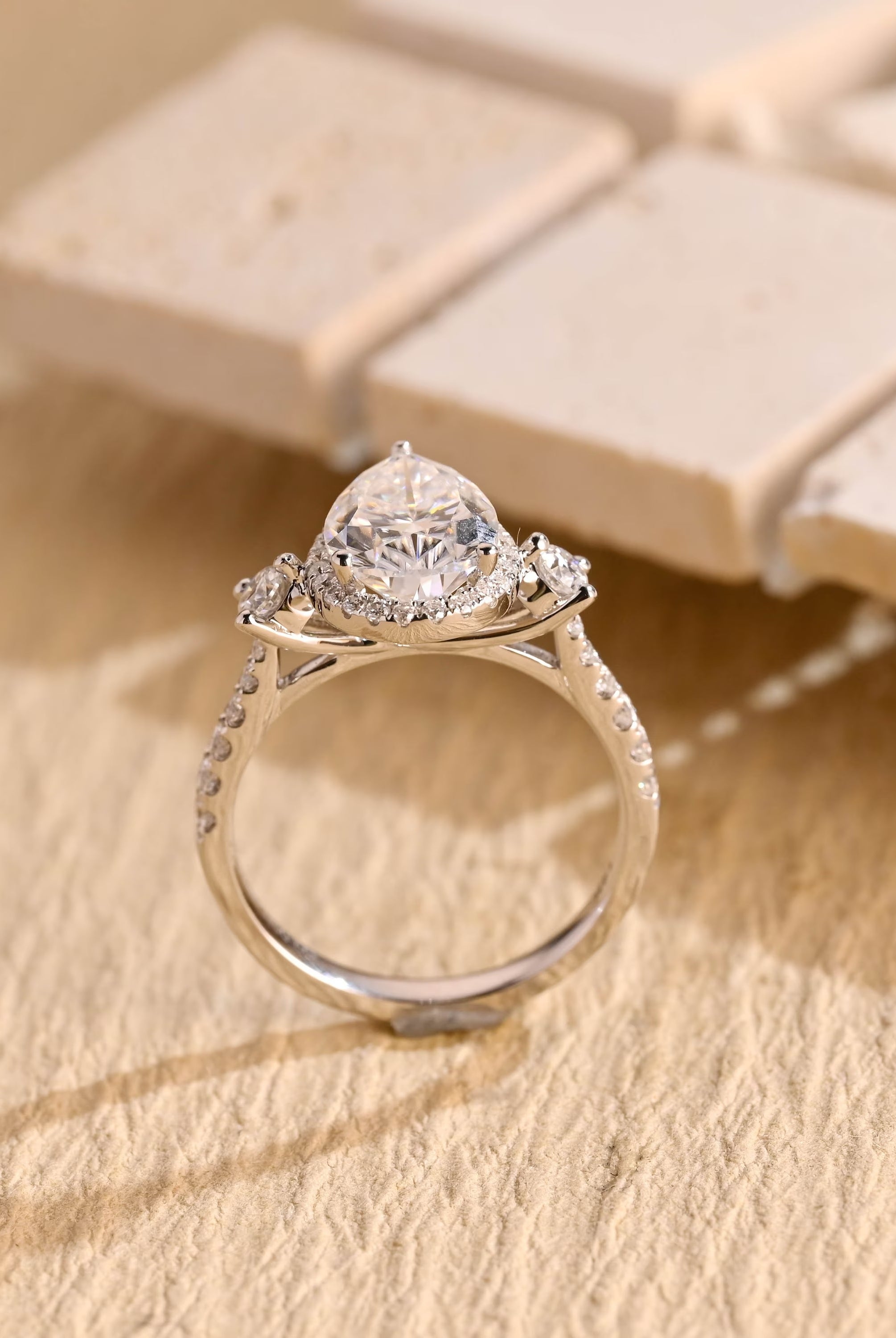 sparkling pear cut three stone moissanite ring