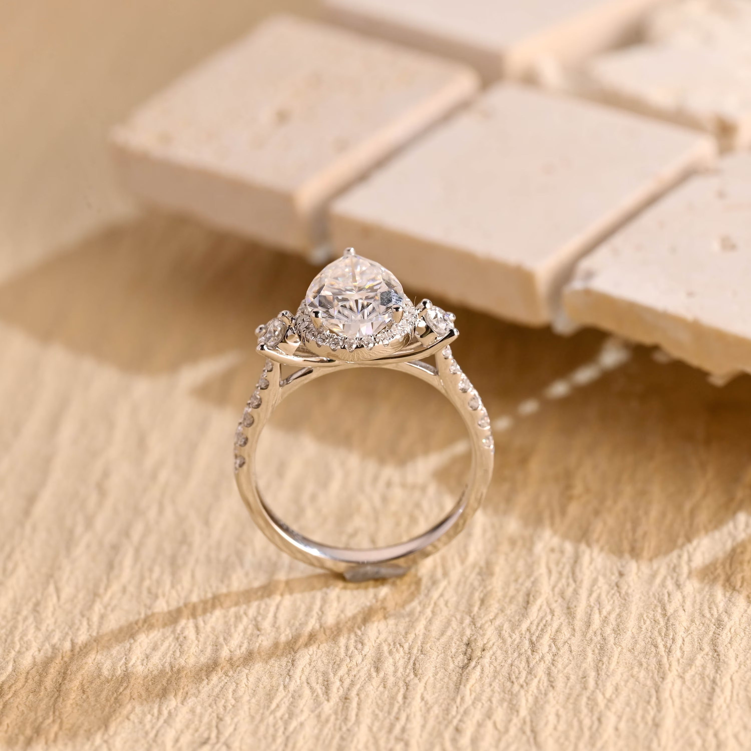 sparkling pear cut three stone moissanite ring