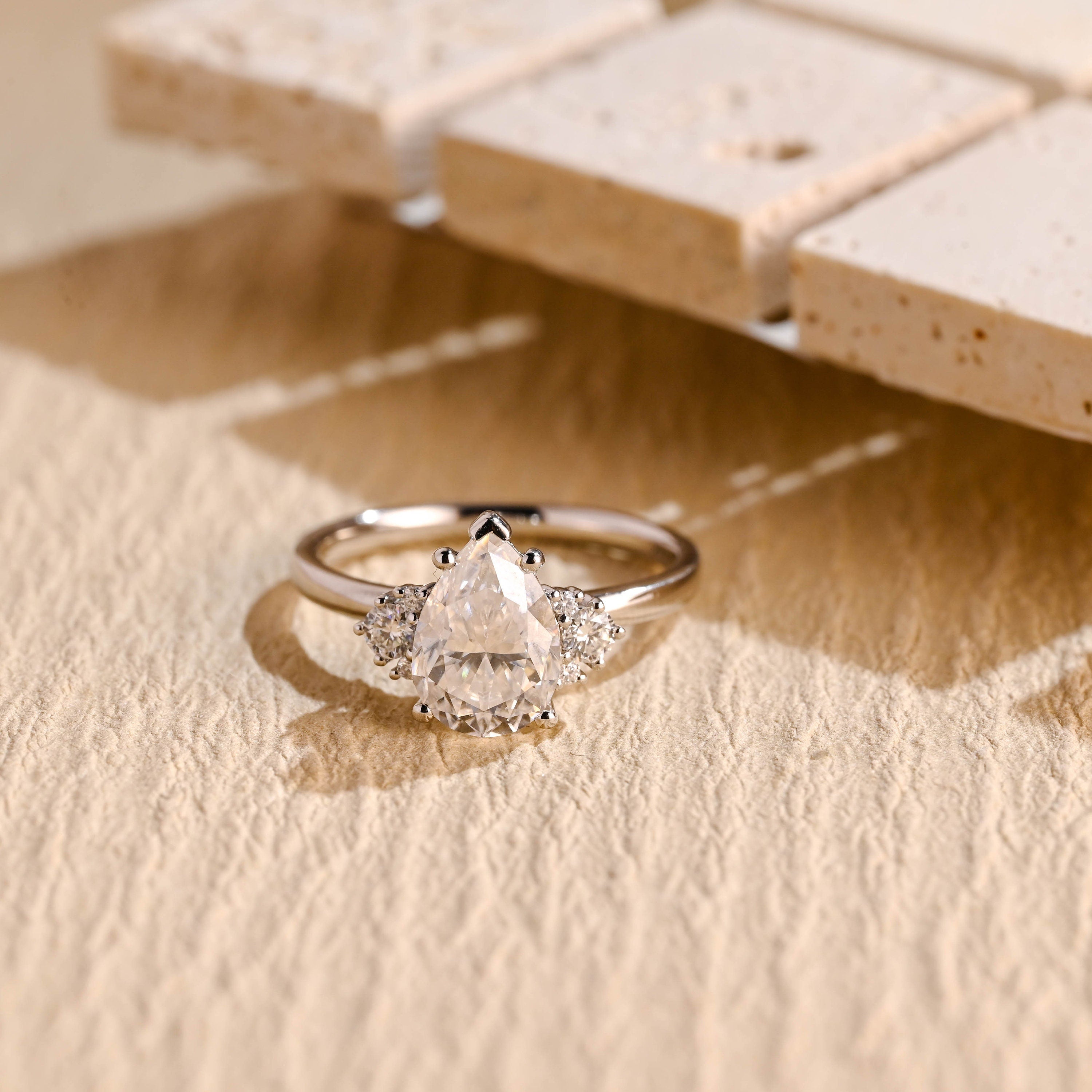 sustainable pear cluster moissanite ring
