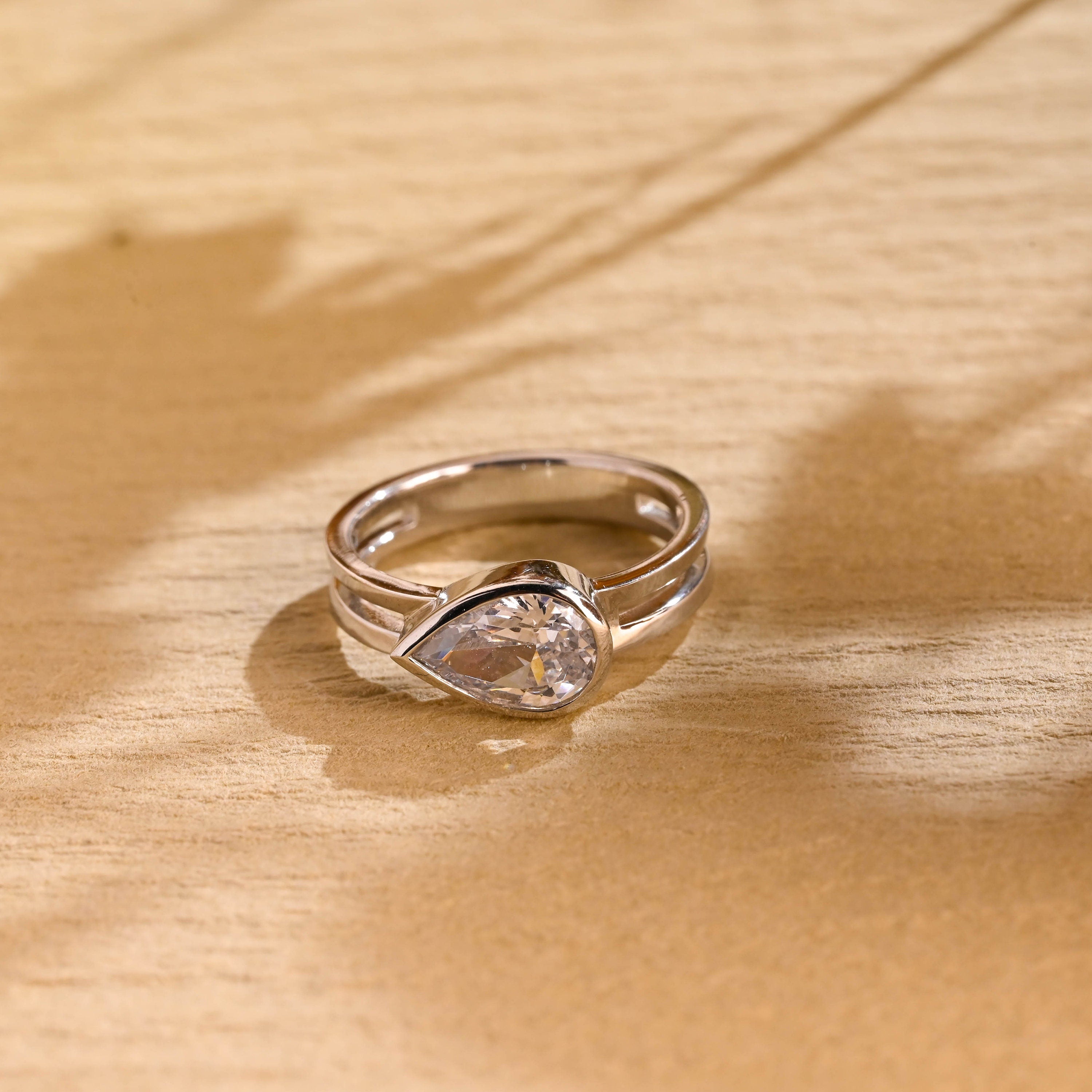 1 carat east west pear bezel engagement ring moissanite