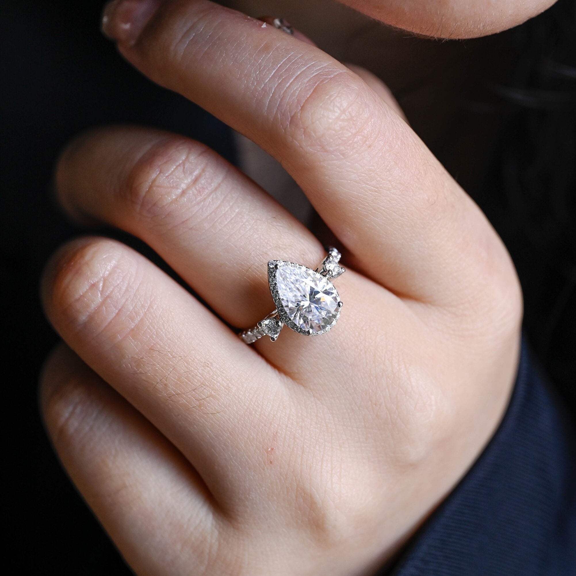 sparkling pear cut three stone moissanite ring