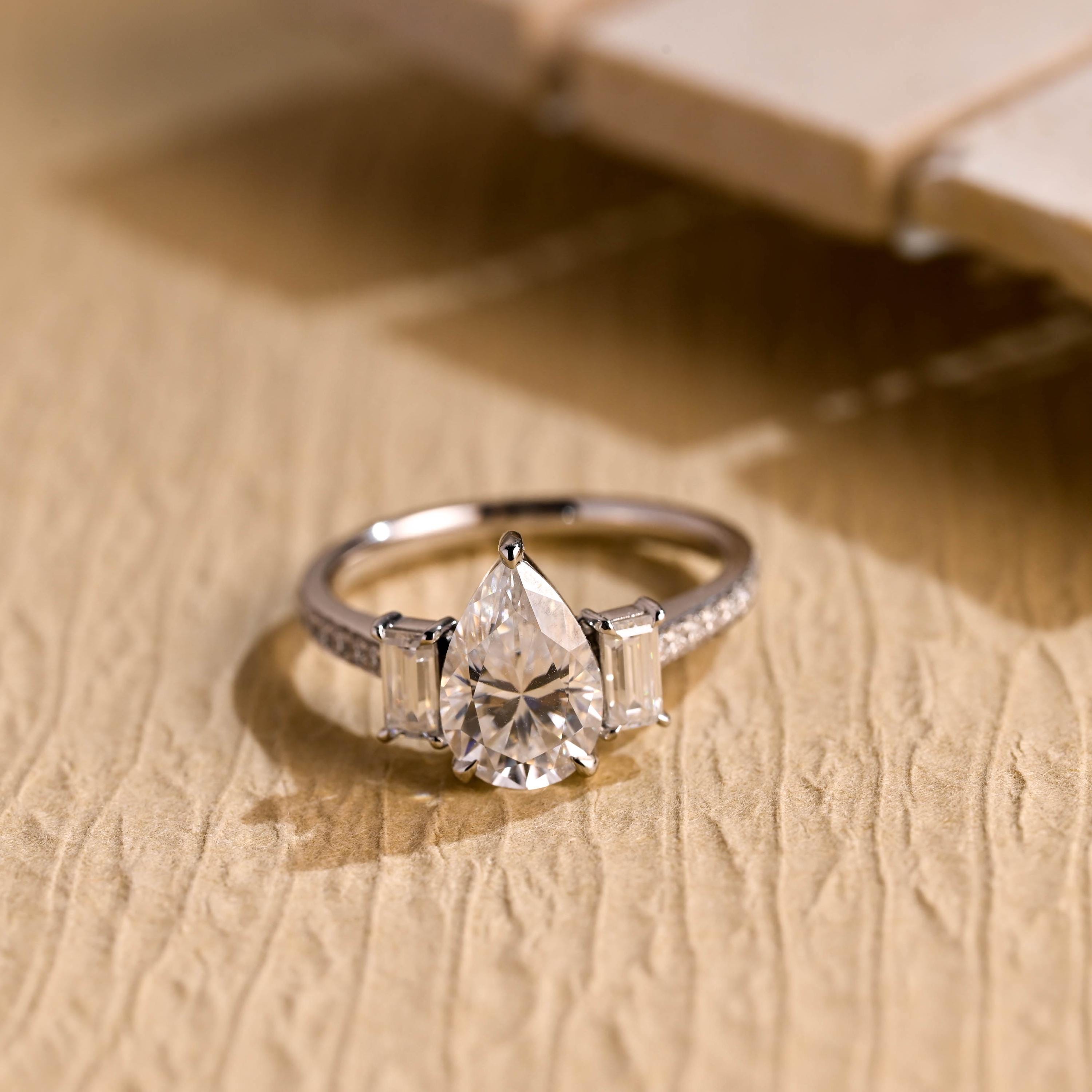 pear cut three stone pavé moissanite engagement ring
