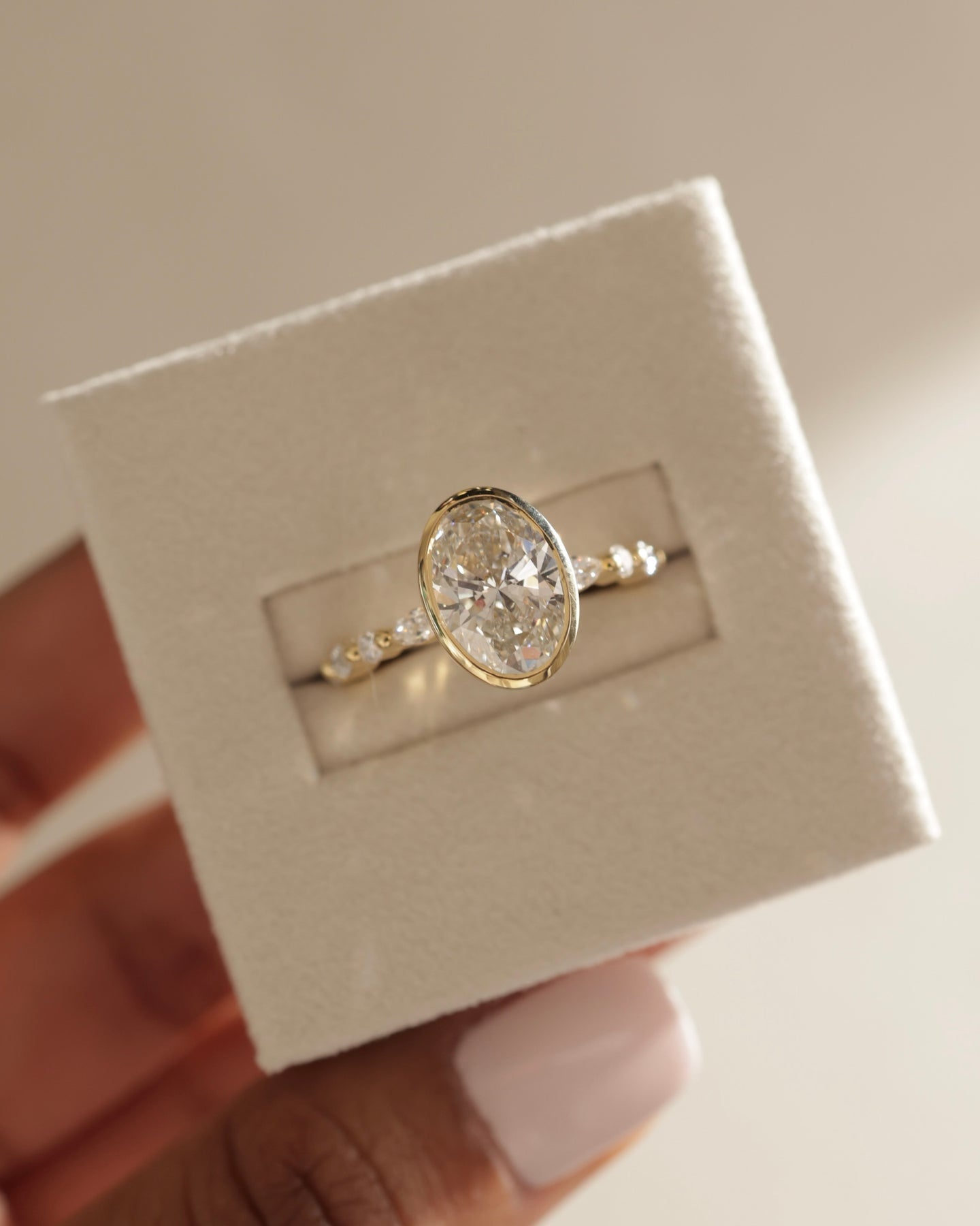 oval diamond ring for her, oval cut diamond gold band, custom oval diamond ring, modern oval engagement ring, oval cut diamond with side stones, oval cut diamond ring setting, oval diamond prong setting, luxury oval diamond ring