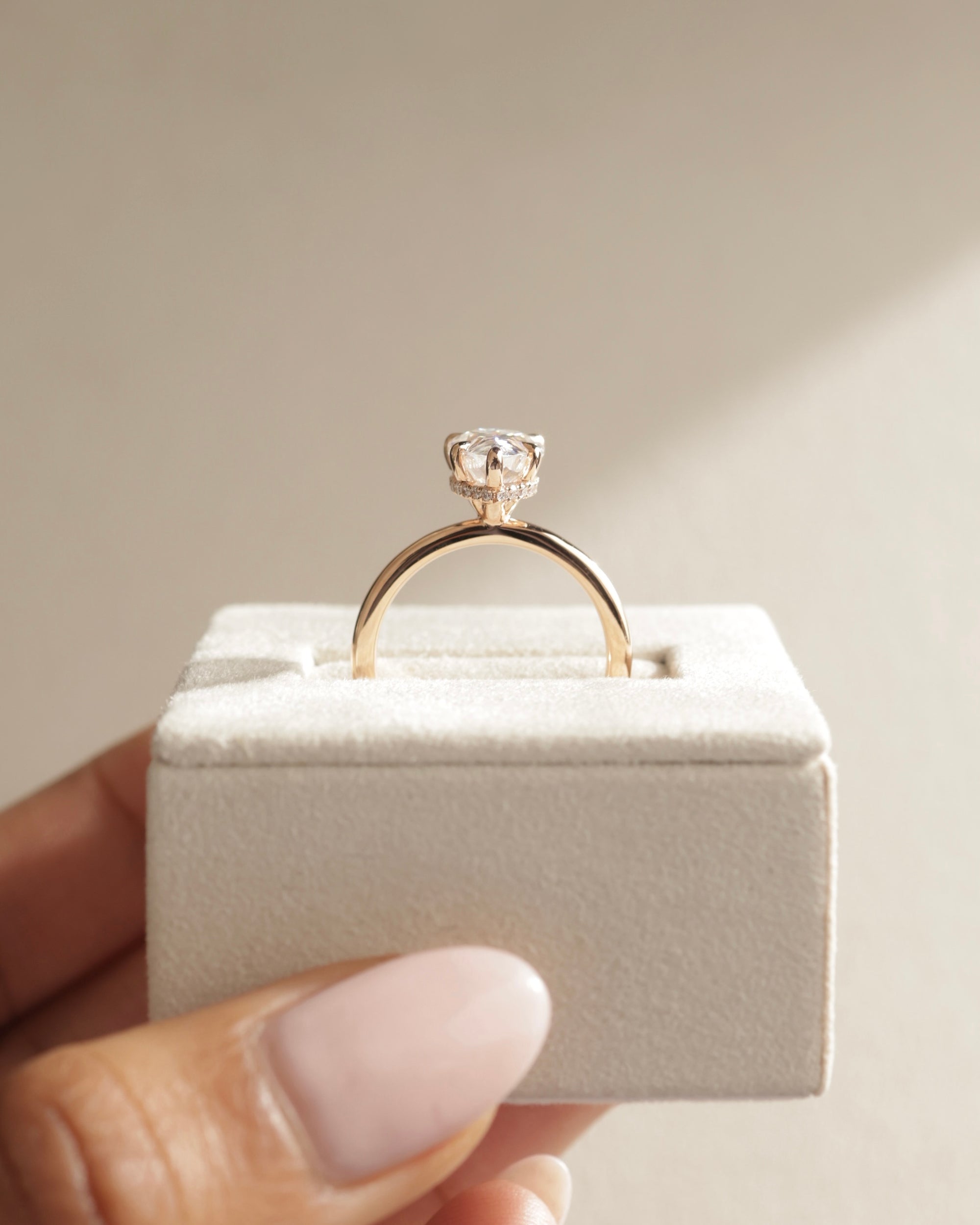 sparkling pear moissanite ring, affordable pear diamond alternative, moissanite hidden halo ring, unique pear engagement ring, pear cut moissanite solitaire ring, handcrafted hidden halo ring, timeless pear cut moissanite ring