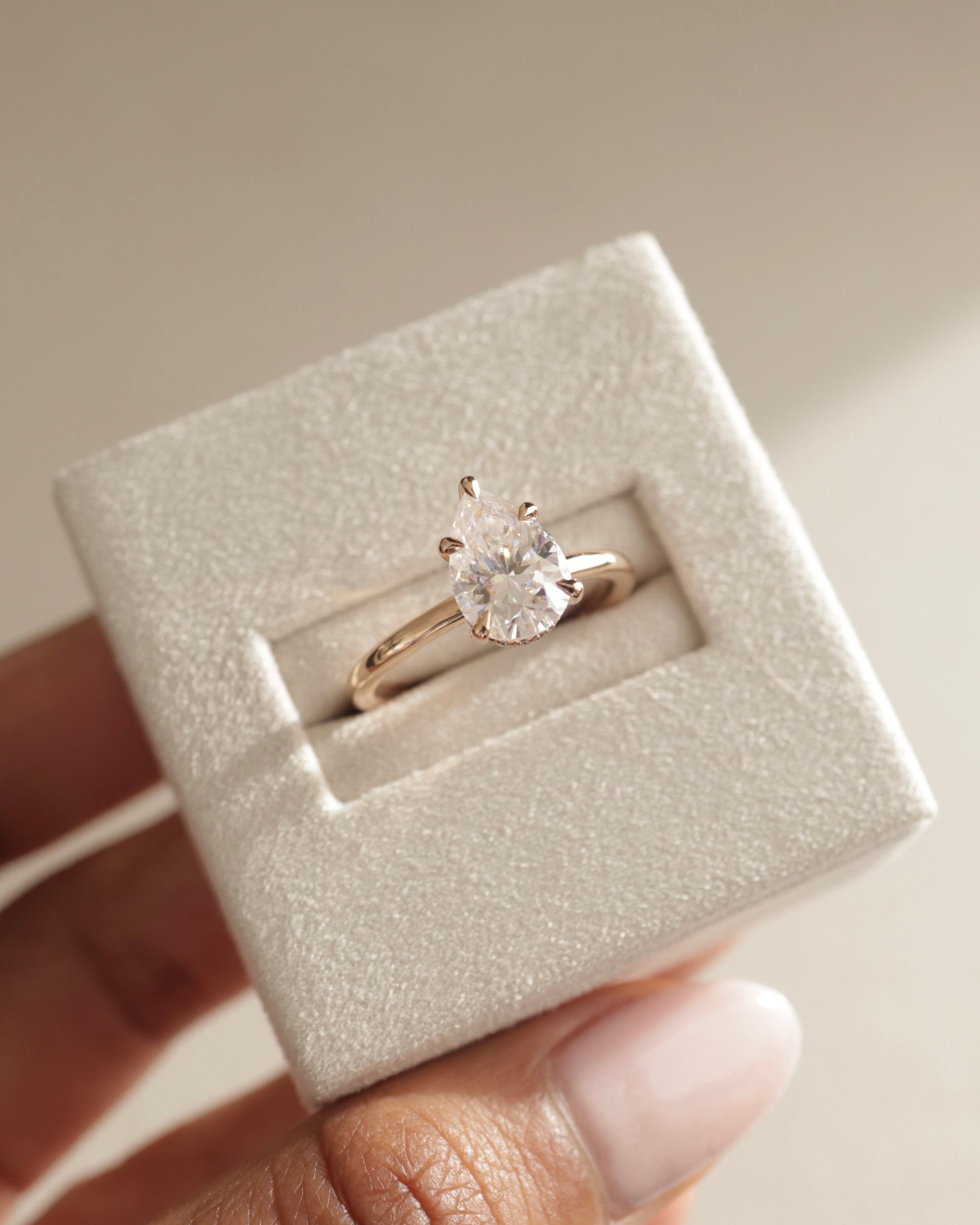 pear shape moissanite halo ring, pear engagement ring with hidden halo, romantic pear moissanite ring, modern pear cut halo ring.