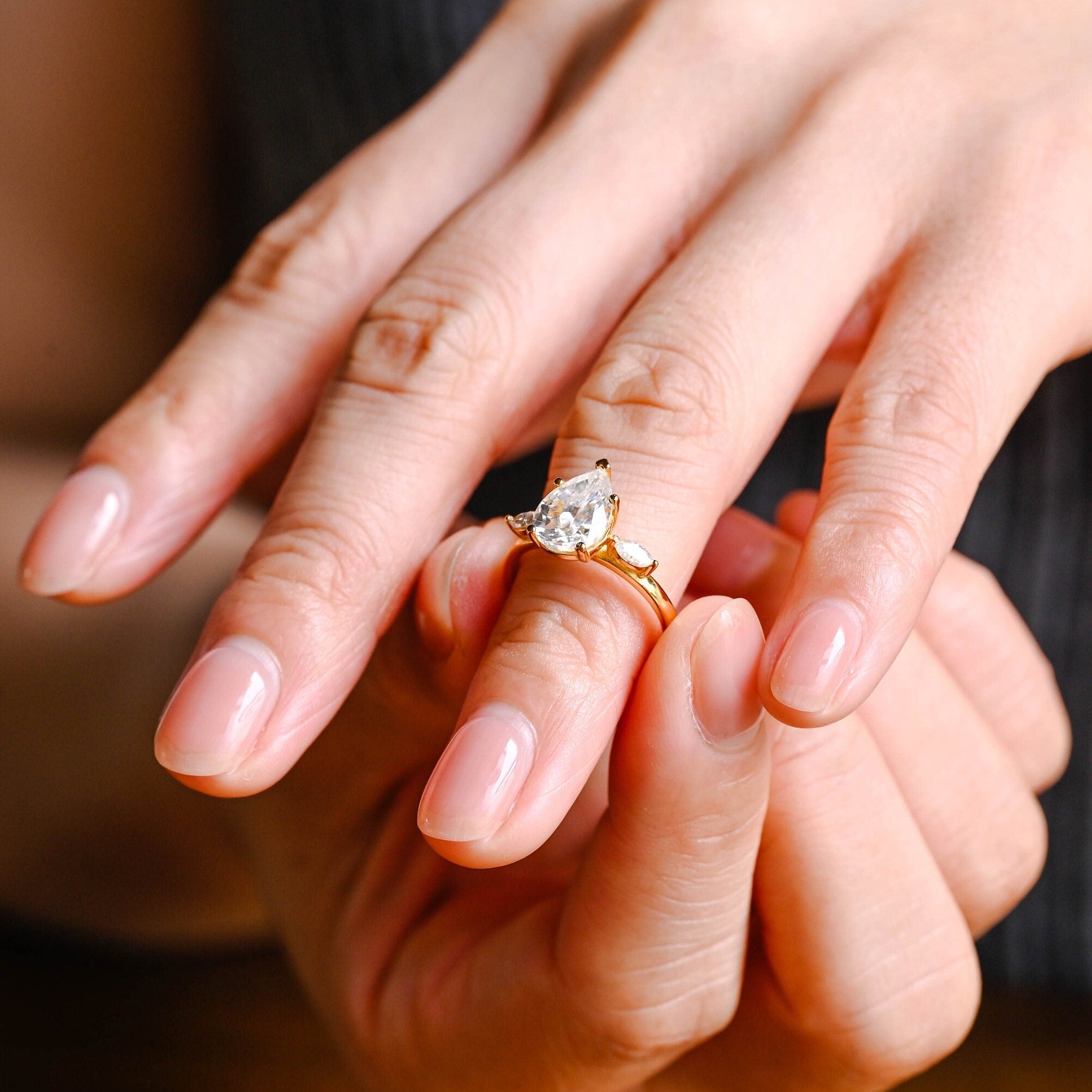 high sparkle pear three stone moissanite engagement ring