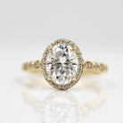 Vintage-inspired three-stone moissanite engagement rings with side stones