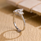 gold pavé three stone pear moissanite engagement ring