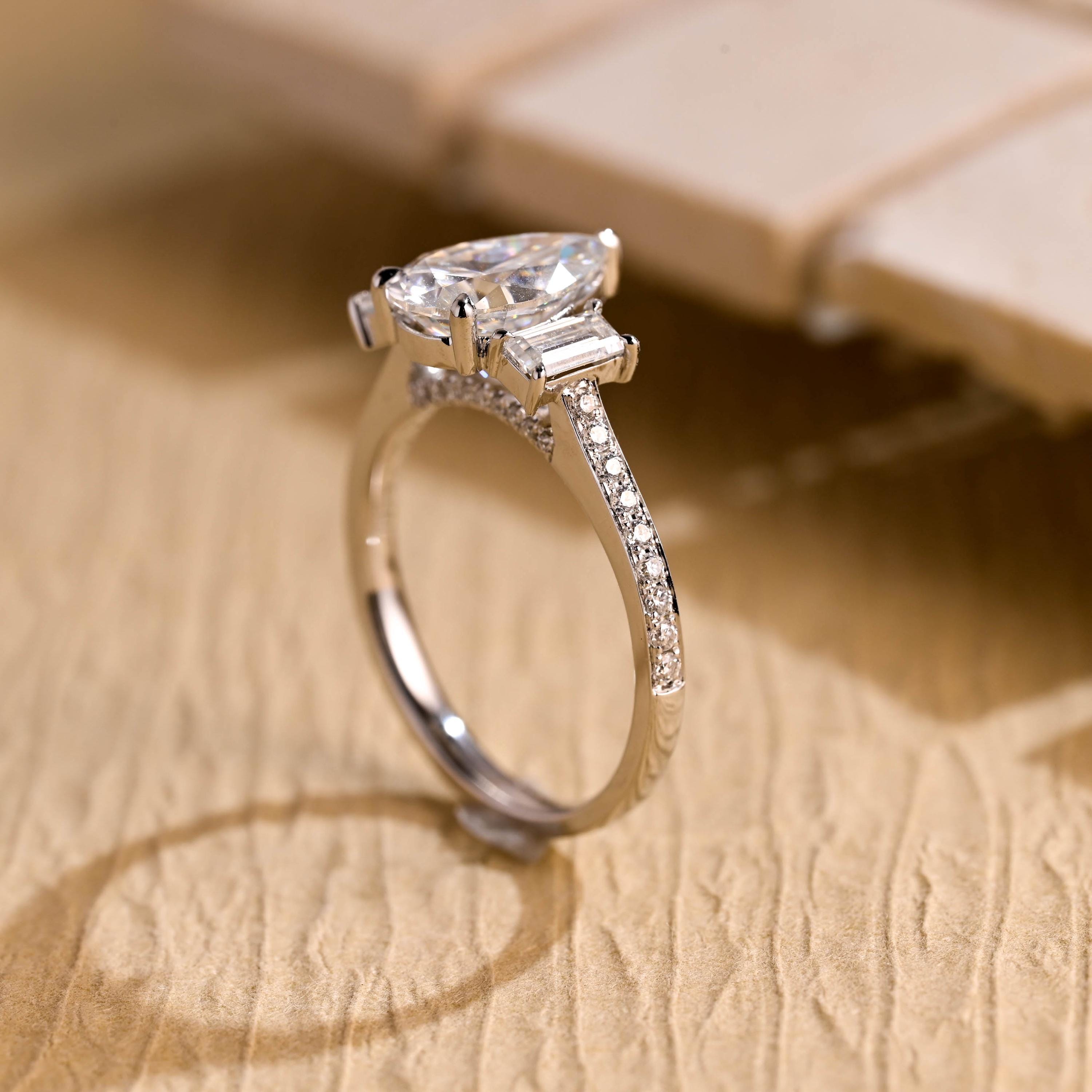 gold pavé three stone pear moissanite engagement ring