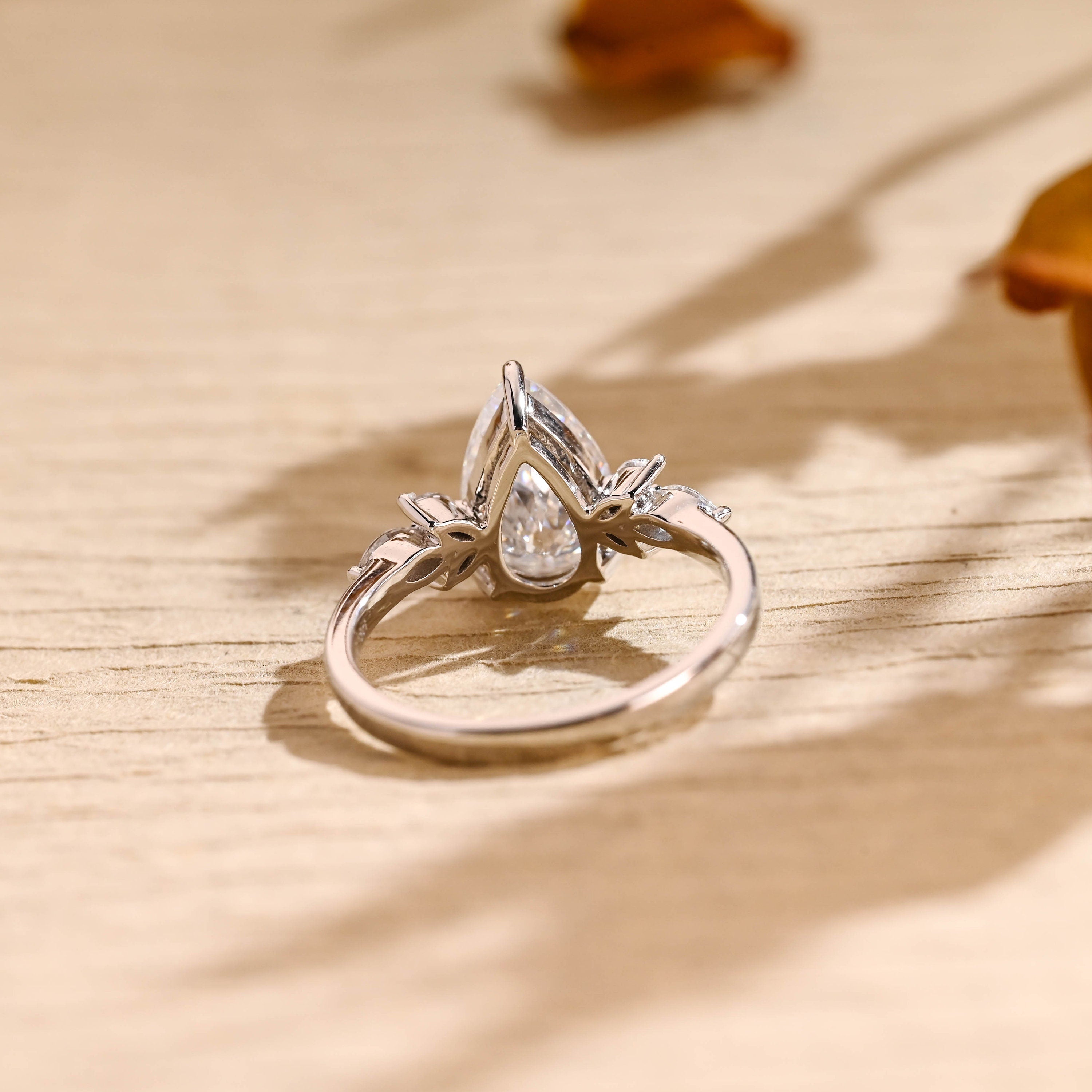 sustainable pear cluster engagement ring moissanite